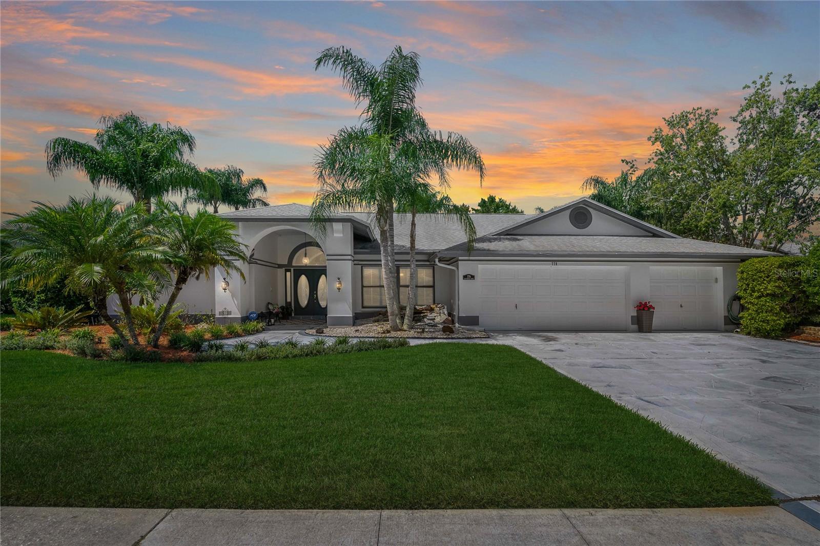 Experience the perfect blend of comfort, style and waterfront tranquility in this stunning 4-bedroom, 2-bathroom, 3-car garage home in the desirable Shadowlake Village at Woodfield in Tarpon Springs. From the moment you arrive, you’re greeted with incredible curb appeal and a peaceful setting, surrounded by lush landscaping and serene pond views that set the tone for a truly special living experience.
Step inside and instantly be drawn to the breathtaking, Southwest-facing water views that fill the home with natural light and offer a front-row seat to brilliant sunset skies each evening. The backyard is a true private retreat, complete with a newly refinished Pebble Tec pool, elegant travertine decking and a covered patio accented with a warm, wood shiplap ceiling. Whether enjoying a quiet morning coffee or entertaining under the golden glow of sunset, this outdoor oasis is unforgettable.
The beautifully appointed kitchen is designed for both function and style, featuring Corian countertops, solid wood cabinetry with convenient pull-out drawers and a charming breakfast nook framed by large bay windows overlooking the water. Just beyond, the family room impresses with vaulted ceilings, a wood-burning fireplace, built-in wall storage, niche display shelving and luxury vinyl wood plank flooring for a modern yet inviting feel.
The split bedroom floor plan ensures privacy, with the primary suite tucked away as its own sanctuary. Enjoy direct access to the pool and patio, a spacious walk-in closet and a spa-like primary bathroom with a dual sink vanity, walk-in shower and a separate soaking tub. Additional highlights include plantation shutters, freshly painted baseboards and a spacious laundry room with generous storage solutions.
The second full bathroom doubles as a convenient pool bath with direct outdoor access, perfect for seamless indoor-outdoor living. Every detail has been thoughtfully designed to create a stress-free, waterfront lifestyle that enhances comfort and well-being.
For travel and commuting, you’re just 18 miles from St. Petersburg/Clearwater International Airport and 22 miles from Tampa International Airport. Plus, the home is located in a top-rated school district with Brooker Creek Elementary, Tarpon Springs Middle and East Lake High close by.
This home is more than just a place to live ~ it’s a true lifestyle. With exceptional water views, a peaceful community setting and a layout designed for both comfort and elegance, this is your opportunity to own a piece of Florida paradise.