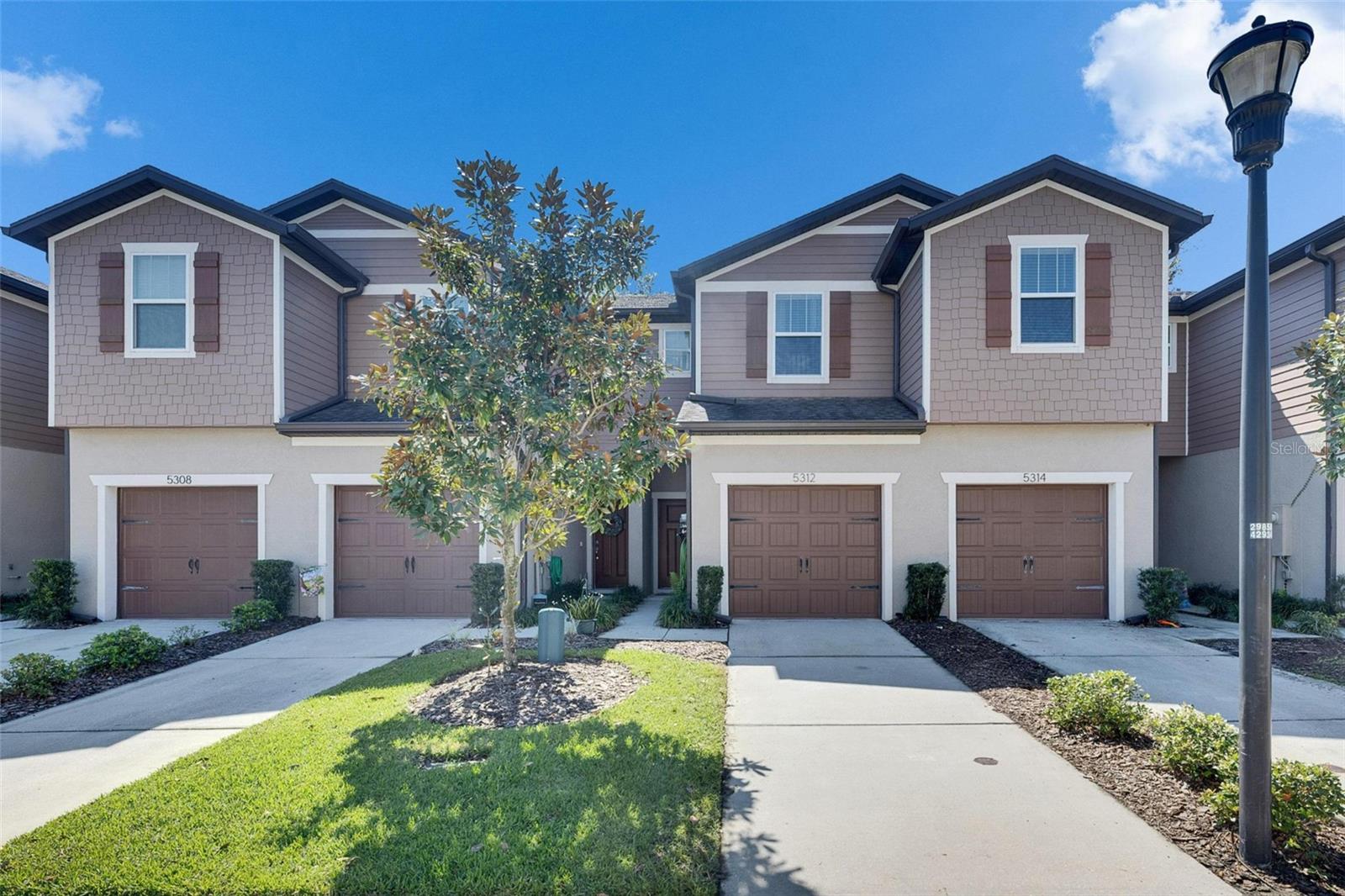 COMFORT AND CONVENIENCE ARE YOURS with this security-gated townhome less than 2 miles / 10 minutes from shopping, restaurants, recreation options, & Interstate 75! You're close to so many destinations, yet you come home to a place that offers a private back patio, a nice neighborhood pool across the street, and your own driveway / 1-car garage. That patio faces south, so you can enjoy sunrise and sunset without direct rays, and your 2-bedroom, 2.5-bath home feels even larger than 1,480 square feet. The tiled downstairs provides a large kitchen with stainless-steel appliances up front, leading to a dining room and then a living room with sliders to the patio. There's also a downstairs lavatory, of course, as well as an upstairs laundry room. Upstairs features carpet in both bedrooms and the long hall separating them at opposite ends of the townhome, with tiled en suite bathrooms. Make your appointment to see this today!