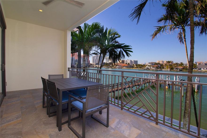Experience the pinnacle of waterfront living in this stunning three-story end-unit townhome, offering 2,794 square feet of beautifully designed indoor and outdoor space. Perfectly positioned along the Intracoastal Waterway, this exceptional residence is just three blocks from the sugar-white sands of Clearwater Beach.

Designed for both comfort and sophistication, the home features 10-foot ceilings, solid-core 8-foot doors, crown molding throughout, luxury vinyl and tile flooring, and impact-rated windows. Fresh interior paint enhances the bright, pristine feel, while three A/C units (2017) and Nest thermostats on every level ensure year-round efficiency and comfort.

Boating enthusiasts will appreciate the private 40-foot deep-water boat slip, complete with electric, water, and Wi-Fi, along with a 10,000 lb boat lift and Jet Ski lift. Enjoy quick access to open water—just 4 minutes to the Intracoastal and 10 minutes to the Gulf of Mexico.

The first floor welcomes you with a spacious foyer, media/entertainment area, and direct views of your private dock. Step outside to a covered waterfront patio, perfect for relaxing or entertaining.

The second floor showcases an open-concept living, dining, and kitchen area tailored for today’s lifestyle. The gourmet kitchen features stainless steel appliances, white shaker cabinetry, quartz countertops, a striking backsplash, and a large center island ideal for hosting. A guest bedroom with walk-in closet and a beautifully appointed full bath is also located on this level. Enjoy serene water views from the covered balcony—perfect for morning coffee or evening sunsets.

The third floor is highlighted by a luxurious primary suite with breathtaking water views and a private balcony. The spa-inspired ensuite bath includes a double quartz vanity, soaking tub, and separate glass-enclosed shower, along with a spacious custom walk-in closet. Two additional bedrooms and a full bath complete this level.

Additional features include an attached two-car garage with a 50 AMP NEMA 14-50R electric vehicle charging outlet.

Residents enjoy a secure, patrolled community with resort-style amenities, including a saltwater pool, spa, grilling area, and beach rinse station.

With a rare 3-day minimum rental policy, this property offers an outstanding opportunity as both a luxury residence and an income-producing investment—delivering the very best of the Clearwater Beach lifestyle.