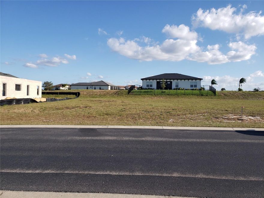 Positioned within the award-winning Water Ridge community in Auburndale, this exceptional homesite at 412 Adams View Lane offers a rare opportunity to build a custom dream home in one of Central Florida’s most desirable gated developments. Renowned for its unique elevated terrain and breathtaking lake vistas, Water Ridge sits high on a natural ridge overlooking Lake Van, Lake Medora, and Lake Alfred, creating a serene environment characterized by unmatched views and refreshing breezes. This premier lot is ideally situated among high-end custom homes, providing the perfect canvas for a luxury build in a community where property values continue to show strong upward trends. As a resident, you will enjoy an impressive collection of resort-style amenities including three swimming pools, an elegant clubhouse with a community kitchen, a fitness center with a sauna, and courts for both tennis and pickleball. For those who love the water, the community provides a private boat ramp and dedicated boat storage, all set within beautifully maintained grounds and scenic walking paths. Strategically located between Auburndale and Lake Alfred, this property offers a peaceful retreat while maintaining convenient access to the best of Central Florida. The community is perfectly positioned near the I-4 corridor, providing a seamless commute to both Orlando and Tampa, and is located less than one hour from Walt Disney World. Furthermore, its proximity to Florida Polytechnic University makes it an excellent location for faculty, staff, or investors targeting academic housing demand. This lot represents a unique blend of upscale resort living and strategic convenience, offering an incredible investment potential in a community that truly sets itself apart from every other development in the region.