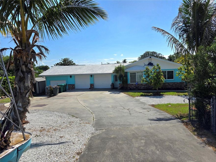 ~Treasure Island~ Waterfront Paradise with Concrete Fortress Charm

This well-maintained waterfront gem offers the perfect Florida lifestyle with two bedrooms and two bathrooms. Solidly built with concrete block walls filled with concrete for ultimate durability, this home features hurricane windows and a recently sealed roof, providing peace of mind during storm season.

Step outside to your personal oasis featuring a seawall (replaced in 2021), boat house with working lift, and fish cleaning station—perfect for the avid angler! Enjoy the 20-foot screened porch, salt water above-ground pool, and bar/spa room for entertaining or unwinding after a day on the water.

Recent upgrades include a maintained air conditioning system with a new fan, attic insulation with a solar exhaust fan, and fresh paint inside and out. The property boasts a tropical fruit garden with banana, star fruit, avocado, mango, papaya, and peach trees.

Equipped with a two-car garage plus bonus workshop space for all your storage needs.
All measurments are approximate.
