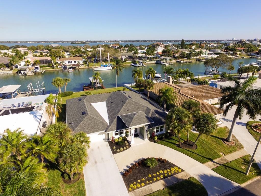 Spectacular Island Estates home. Completely renovated inside and out in 2018. New windows, doors, kitchen and baths. New roof, A/C, gas water heater and flooring throughout. Spacious open foyer with soaring ceilings. 4 bedrooms, 3 1/2 baths. Open floor plan with volume ceilings. Huge great room opens to covered outdoor space. Beautifully landscaped, oversized lot with pool and covered boat dock with lift. Walk, bike or boat to all that Clearwater Beach has to offer. Previous offer fell through due to financing. For info and showings call owner.