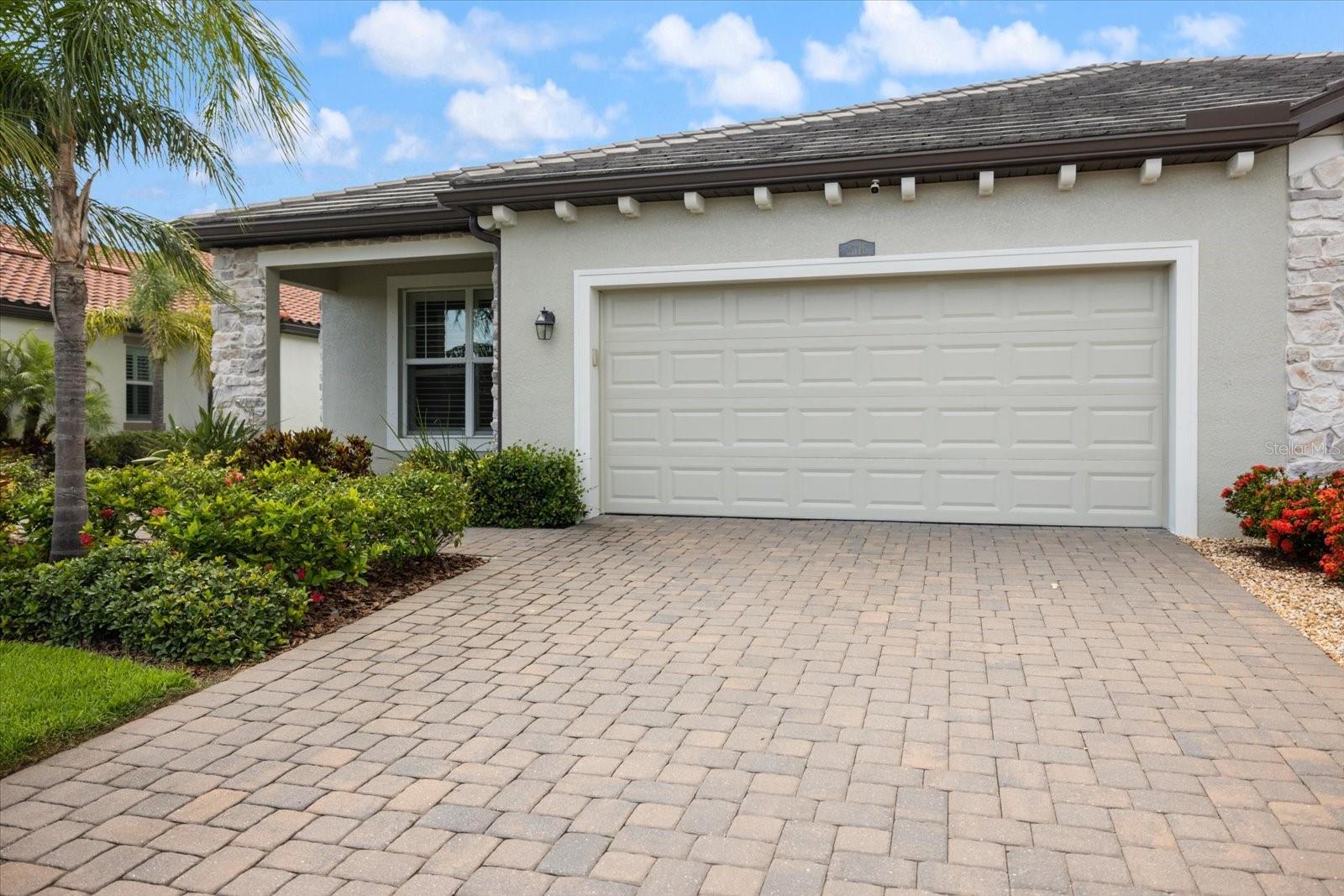 Unbeatable Location NEXT TO THE COMMUNITY POOL in the Heart of Lakewood Ranch! Welcome to one of the largest villas available in the gated community of Arbor Grande. Inside you’ll immediately notice the abundance of natural light, elegant crown molding, and porcelain tile flooring throughout the main living areas. With 2 bedrooms, 2 bathrooms, and a versatile den, this open-concept layout offers both functionality and sophistication. The primary suite is a peaceful retreat featuring dual walk-in closets, a spacious ensuite with double vanities, a private water closet, and a walk-in shower. On the opposite side of the home, a second bedroom and full bath provide privacy and comfort for guests. The gourmet kitchen has granite countertops, 42” upper cabinets, stainless steel appliances, and a large center island—ideal for both cooking and entertaining. Adjacent to the kitchen, the den with French doors offers the perfect space for a home office, media room, or cozy reading nook. Enjoy Florida living at its finest from the screened-in lanai where you will enjoy a partial water view. Upgrades include: crown molding in main areas and primary suite, plantation shutters and motorized shades, brick paver driveway and walkway, epoxy-coated garage floor, 250V outlet for electric vehicle charging and lush professional landscaping. Directly across the street, residents enjoy a private, saltwater pool and spa, along with pickleball courts and a dog park—exclusively for villa owners. Arbor Grande also features a state-of-the-art fitness center, clubhouse, a second resort-style pool, bocce ball, and volleyball courts. Plus, a full-time lifestyle director keeps the social calendar full with events for all ages. Enjoy peace of mind with fully maintained exteriors, giving you more time to relax and explore. With three direct access points to Bob Gardner Park, you can enjoy walking trails, a dog-friendly swimming lake, frisbee golf, a playground, and covered picnic areas—all just a short stroll (or golf cart ride!) away. This beautifully upgraded villa offers an incredible opportunity to embrace a luxurious and active lifestyle in the heart of Lakewood Ranch. Don’t wait—schedule your private showing today and make this exceptional home yours!