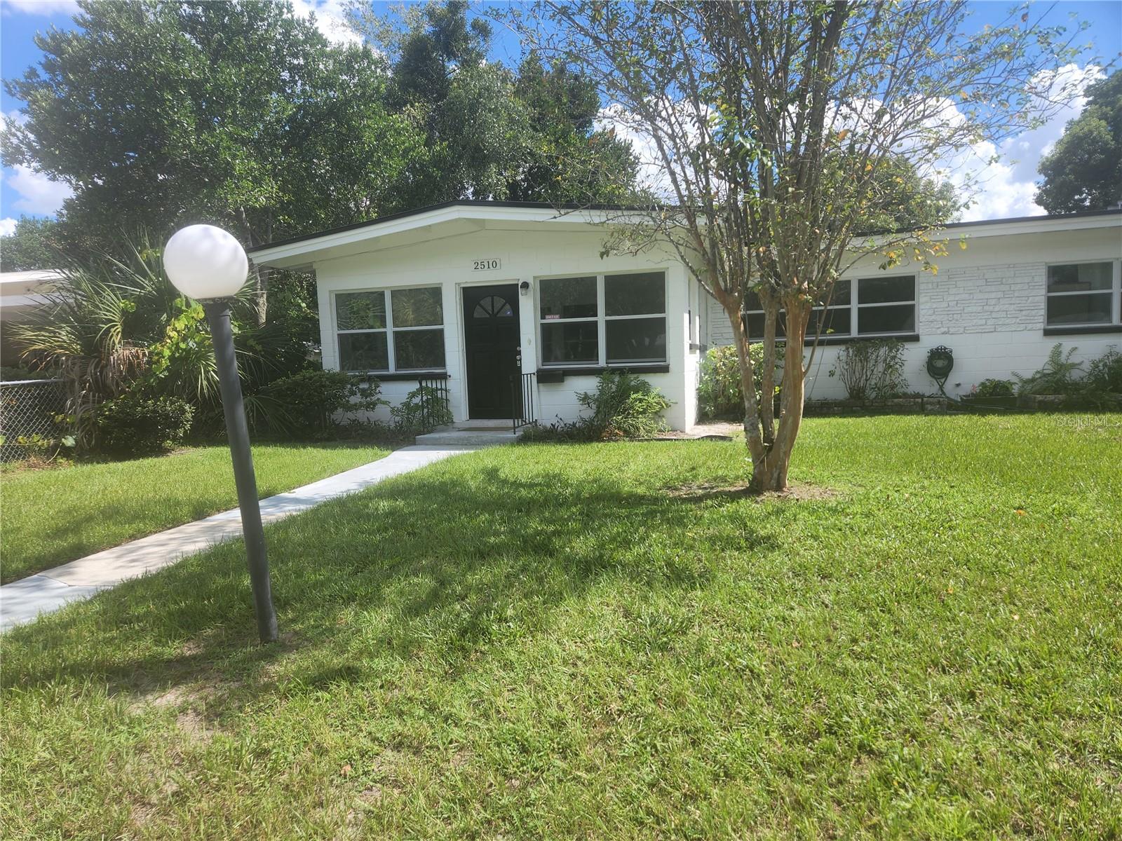 This beautifully renovated half-duplex is just blocks from Lake Killarney, ideally situated between College Park and the Winter Park shopping district. Enjoy quick access to local favorites like the Orlando Science Center, Winter Park Village, and Mead Gardens—all just minutes away.
The home features 2 bedrooms, 1 bathroom, and a dedicated carport for convenient parking. Inside, you'll find polished terrazzo floors, a modern kitchen and bathroom with solid surface countertops and brand-new cabinetry. Additional highlights include inside laundry, a partially fenced yard, and a private storage room for each unit.
Lawn care is included. Small to medium pets are welcome with an approved application and applicable pet fees/rent. Call today for a viewing!