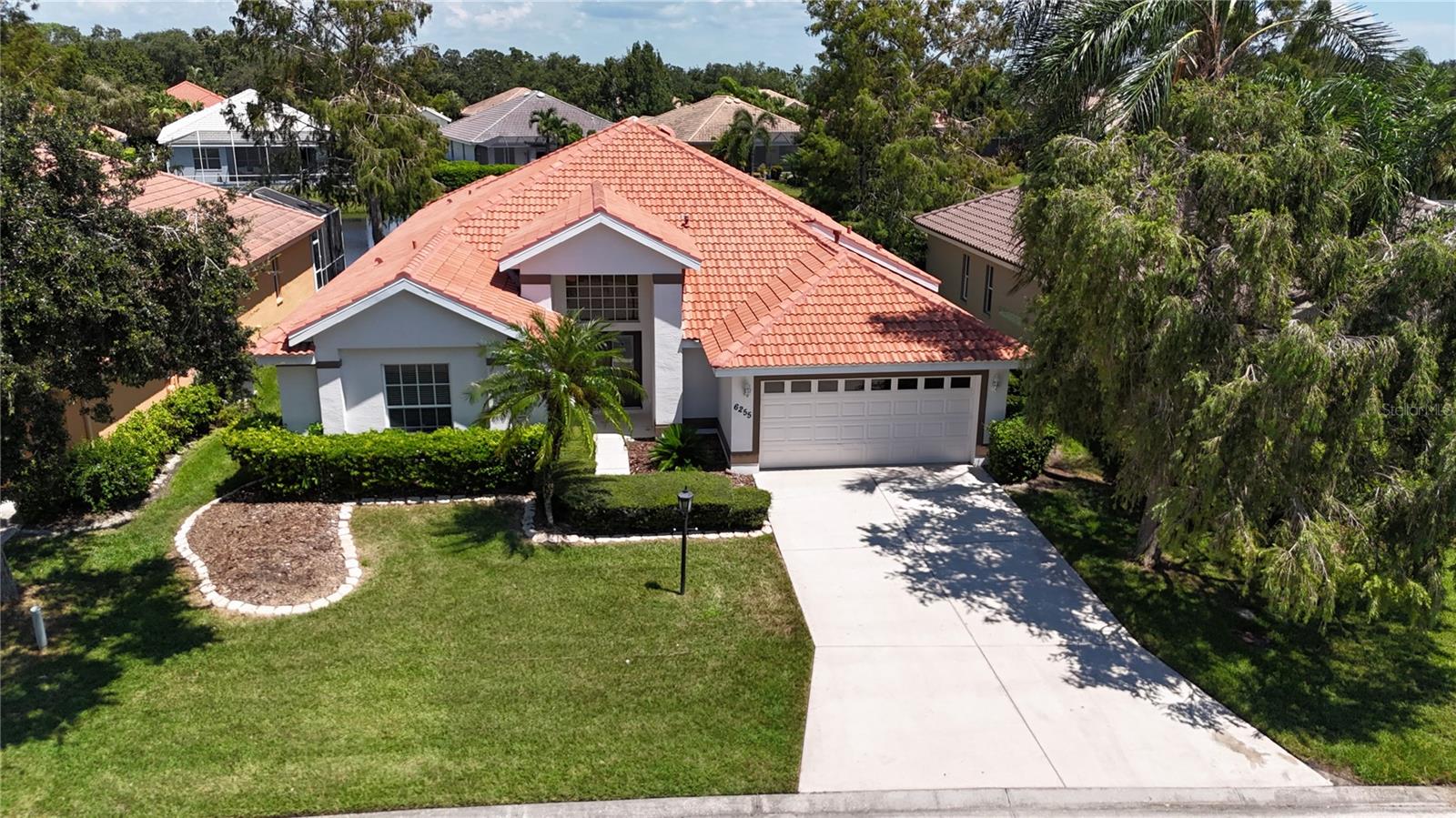 Come experience the best of Florida living in this beautifully updated home in "The Hamptons" subdivision at Palmer Ranch. Nestled in a picturesque, landscaped community, this stunning residence boasts porcelain tiles throughout the main living areas and soft vinyl flooring in all four bedrooms—no carpet anywhere! A SPACIOUS PRIMARY BEDROOM WITH a generouse size walk-in closet, 3 additional bedrooms, One of the guest rooms can easily serve as a HOME OFFICE. The open kitchen features elegant wood cabinets, granite countertops, and stainless steel appliances, perfect for any culinary enthusiast. With designer baseboards, a mix of vertical and horizontal blinds, high ceilings, and spacious rooms filled with natural light, every corner of this home exudes charm and comfort. Additional highlights include an inside laundry room with a sink, a roomy two-car garage with a workshop area, or extra storage space. Relax and enjoy the breathtaking lake views from multiple rooms, or unwind in the screened-in lanai overlooking your private pool. The community offers miles of convenient sidewalks and a community pool. The popular Legacy Trail is just around the corner, along with a state-of-the-art YMCA, excellent shopping, dining options, and the world-famous Siesta Key Beach, just minutes away. Don’t miss this opportunity—make an appointment to see this incredible home today before it's gone!