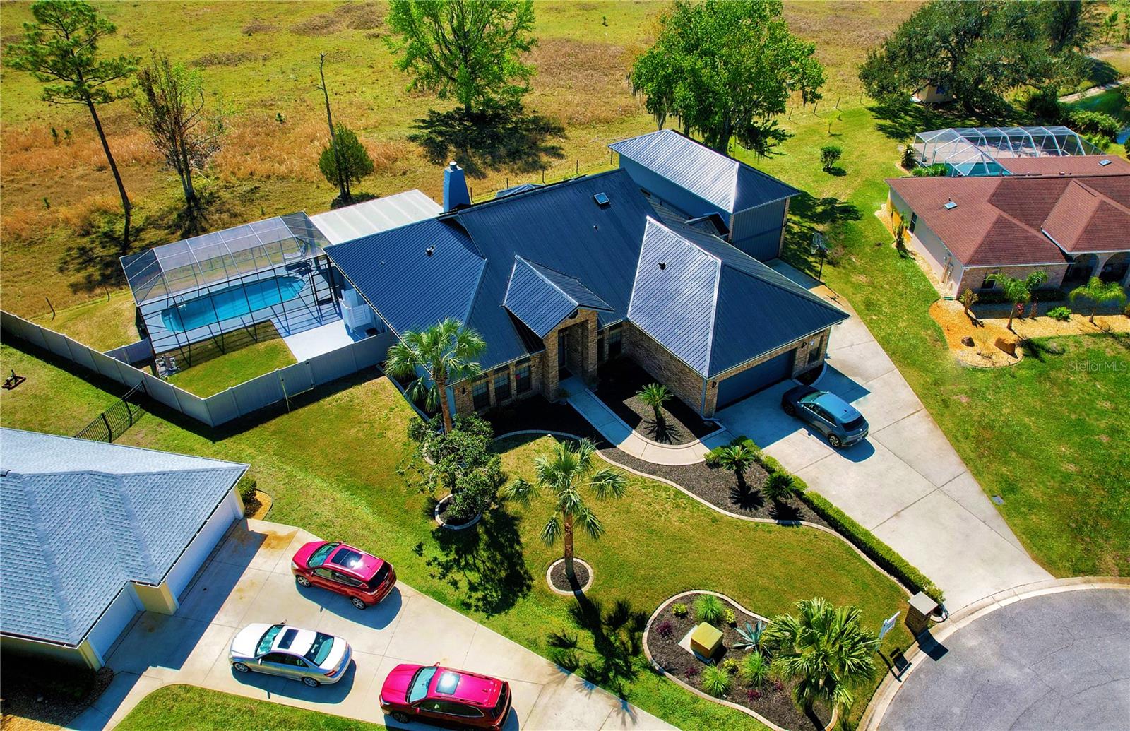 Welcome to 1948 Spruce Creek Landing, an exclusive estate in the renown, **24-hour gated Spruce Creek Fly-In, a premier **Florida Coastal Aviation Community, designed for those who seek luxury, space, and convenience. Spanning over **6,000 sqft, with 3,787 sqft under air, this residence is one of the largest in the area and features a **highly coveted, fully air-conditioned 40x15 RV garage**—a rare find in this subdivision—complete with a workshop, two-tier loft storage space, and a **state-of-the-art Stage 2 electric car charger for ultimate convenience.
From the moment you step inside, soaring **vaulted ceilings create an airy, expansive feel, enhancing the home’s luxurious ambiance. Every detail has been meticulously crafted, from the sleek modern fireplace to **designer cabinetry, custom showers, vanities, sinks, water and lighting fixtures, and Venetian plaster accents. **The 156" HD projection TV offers a **private cinematic experience, while the **spa-inspired master suite features the **easy clean and maintenance of a full venetian plaster wet room with a large soaking tub, a multi-spray shower system, and a smart bidet/toilet.
Built for durability and elegance, this home boasts **solid concrete block construction with a stucco and brick exterior, ensuring lasting strength. Plus, a **brand-new metal roof, installed in February of this year, adds even more longevity and value.
Outside, your **private oasis** awaits with a screened-in pool and a spacious shaded outdoor entertainment area. A **fire pit with a built-in blower guarantees cozy evenings under the stars, while the **owned solar electric system, provides eco-friendly and cost-efficient energy solutions.
As a resident of Spruce Creek Fly-In, you’ll enjoy access to **private airports and hangars, 14 miles of biking and hiking trails, limousine services, tennis courts, and a 18-hole golf course. The community thrives with parades, parties, and celebrations, ensuring a vibrant lifestyle year-round.
This is more than a home—it’s a **rare opportunity** to own one of the most exclusive properties in this elite aviation community, where luxury, space, and world-class amenities come together in perfect harmony.