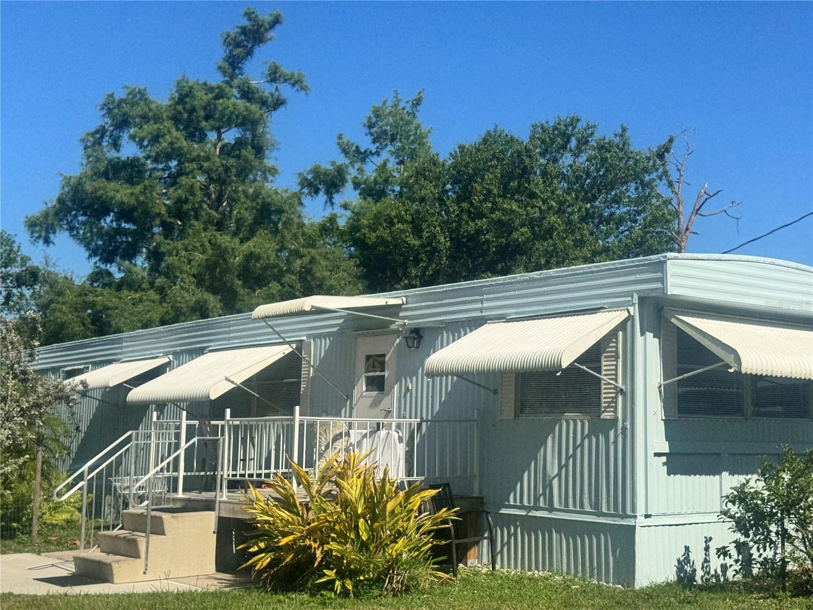 Great Investment Opportunity – No HOA Fees. As Is Cash Deal! This unique property near Lake Suzy offers incredible rental potential or the perfect getaway retreat. Set among lush landscaping, you’ll find a two-bedroom mobile home, a one-bedroom efficiency in-law suite apartment, and an RV in the back that stays with the property—providing the possibility for three separate rentals. The in law suite is a separate efficiency remodeled w newer kitchen and bath. Separate entrance makes for a great little air b n b. One of kind property. The property is furnished turn key and overlooks lush beautiful trees and greenery, creating a private and peaceful setting. Whether you’re looking to generate income or enjoy a versatile property with multiple living spaces, this is a must-see! Did I mention there is boat parking or RV parking a carport and circular drive with plenty of parking. So many possibilities to make this Oasis. Furnished with lots of extras and all appliances stay. Two sets of washer and dryer and kitchen appliances stocked kitchen. This is a special property a great opportunity for snow birds who want to have a winter get away!