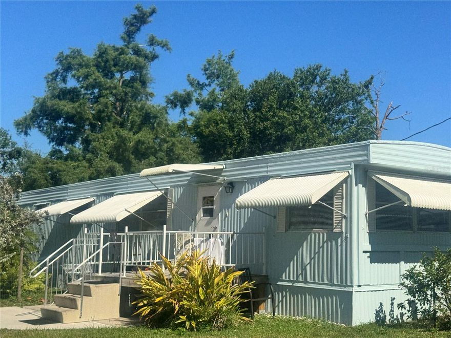 Wow What a Deal 3 bedrooms 2 baths plus RV on Oversized Lot and a half - Turn Key No HOA Fees.  Two family home 2 bedroom 2 bath home with In Law suite incredible winter home or rental potential or the perfect getaway retreat. Set among lush landscaping, you’ll find a two-bedroom mobile home, a one-bedroom efficiency in-law suite apartment, and an RV in the back that stays with the property—providing the possibility for three separate rentals. Great Investment Opportunity – The in law suite is a separate efficiency remodeled w newer kitchen and bath. Separate entrance makes for a great little air b n b. One of kind property. The property is furnished turn key and overlooks lush beautiful trees and greenery, creating a private and peaceful setting. Whether you’re looking to generate income or enjoy a versatile property with multiple living spaces, this is a must-see! Did I mention there is boat parking or RV parking a carport and circular drive with plenty of parking. So many possibilities to make this Oasis. Furnished with lots of extras and all appliances stay. Two sets of washer and dryer and kitchen appliances stocked kitchen. This is a special property a great opportunity for snow birds who want to have a winter get away!