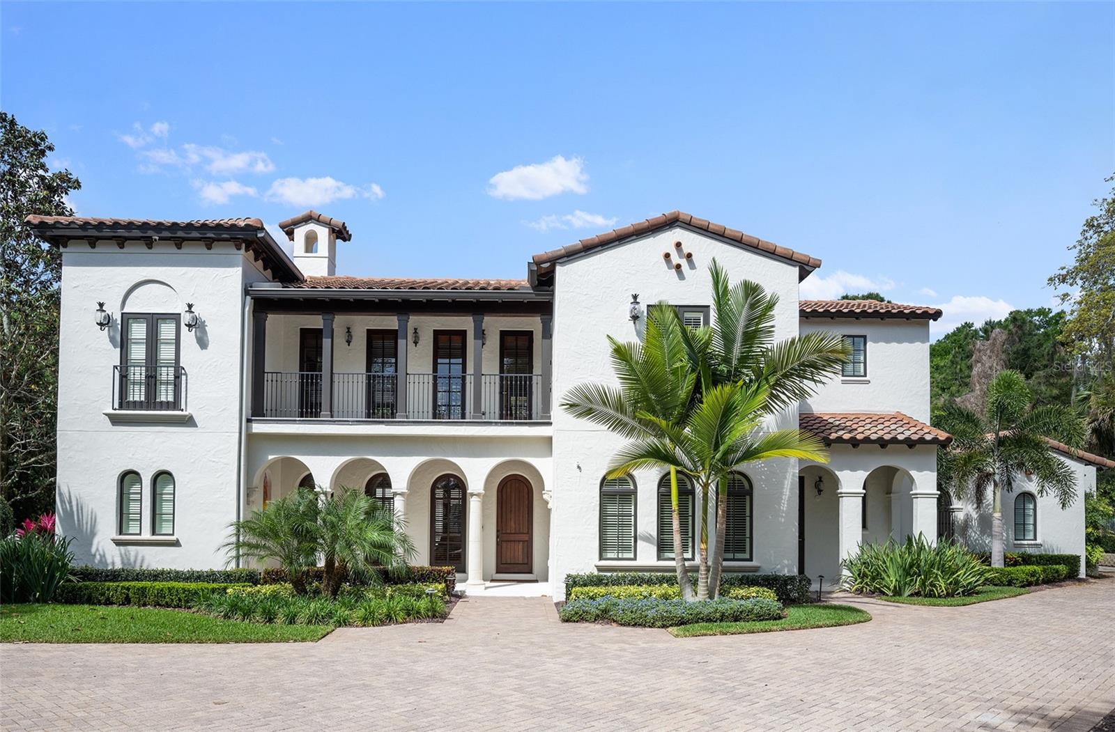WINDSONG - WINTER PARK – A Maroon Fine Homes masterpiece and COMPLETELY renovated in 2022. This property combines luxury, functionality, and location, making it a perfect choice for those looking to enjoy the best of Winter Park living! Five bedrooms, six baths with the amazing primary suite located on first floor and shell stone flooring though out entire home except theater room. Master suite features a luxurious bath with double vanities, separate shower and tub plus washer and dryer in large walk-in closet to save a trip to the laundry room on the other side of this 6,215 sq. ft. home. From the living room with fireplace, you enter the informal dining area, large open kitchen, and a grand family room. A gourmet kitchen offers a hidden walk-in pantry, wonderful center island with nice long counter for seating open to the family room. Kitchen includes Dacor appliances with unmatched design, American made and the preferred choice for culinary enthusiasts. An office is on the first floor off from the foyer, which leads to a butler’s pantry (with another large walk-in pantry), which is adjacent to the large laundry room with another set of washer/dryer, and a custom dog bathing area! Across from the living room is a bedroom with ensuite bathroom perfect for guests or mother-in-law needs (pocket door separates this area from living room). Additionally downstairs is a theatre room with comfy chairs for family fun nights! Just outside the theatre room is a hall bar area with subzero tall wine fridge w/2 refrigerated beverage drawers/ 2 more subzero ones, another refrigerator and freezer w/ice maker and a pool full bath just down the hall. Upstairs is an open space perfect for a library, play area, another living room, etc. and is positioned between three more bedrooms with ensuite bathrooms. To enjoy morning coffee or evening wine there are 4 porches and 2 balconies. 3 garage spaces.....2 car garage and separate 3rd garage. The lay out of this luxury home is unique as it wraps around (U shape) the pool, lanai, and outdoor kitchen. Three a/c units replaced in 2014. Large, private backyard with NO rear neighbors. Located in one of Winter Park’s most sought-after neighborhoods, Windsong offers its residents Chain of Lake Access, community pools, splash park, pontoon boat, paddleboards. Top rated schools and minutes to Park Avenue shopping and dining.