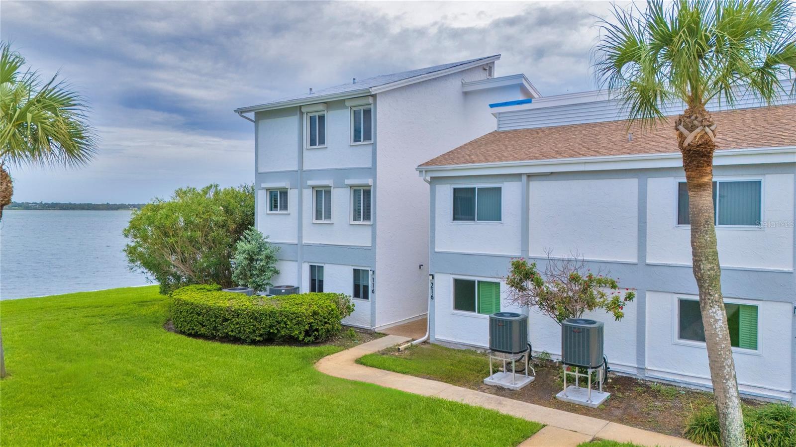 Rare End-Unit turn-key furnished ANNUAL RENTAL AVAILABLE NOW (would entertain seasonal rental with 90-day minimum stay) with Stunning Water Views in Bayside Gardens I on Sand Key - the best part of Clearwater Beach!! Discover a truly exceptional coastal retreat in this rare end-unit townhome, showcasing panoramic water views from every room. This light-filled and spacious 3-bedroom, 2.5-bath residence brings you the best in waterfront living. Kayak or fish just steps from your door! Step inside to a clean, beautifully furnished home where an open floor plan connects the living and dining areas, creating a seamless, airy space ideal for both entertaining and relaxing. A large PRIVATE BALCONY, complete with motorized retractable awning offers unobstructed views of the Intracoastal Waterway and dazzling sunrises—with a myriad of dolphin and manatee sightings to complete the picture. The home has been thoughtfully updated, featuring HURRICANE IMPACT-RATED WINDOWS, newer FLOORING and NEW SAMSUNG BESPOKE kitchen appliances. The serene primary suite includes a beautiful ensuite bath with ample closet space, while a large interior storage closet and assigned covered parking just steps from your door add everyday convenience. Set on beautifully landscaped grounds, the community offers RESORT-STYLE AMENITIES including a heated pool, covered poolside lanai, gas grills, outdoor gas fireplace, and shaded dining spaces. Perfectly positioned near Sand Key Park, this unit offers convenient access to nearby shopping, dining, and attractions right in front of the complex. Travel is effortless, CLOSE to downtown Clearwater, with Tampa International Airport just 30 minutes away and St. Pete/Clearwater Airport only 15 minutes by car. This is coastal Florida living at its finest—turnkey, tranquil, and just steps from the sand. Don't miss this excellent opportunity! Call today for your private showing!