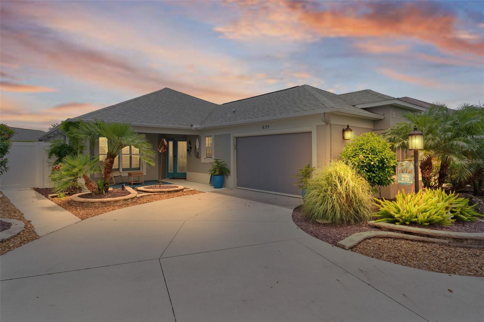 Exquisite WYNDHAM MODEL Oasis in Vibrant MISSION HILLS. Step through the shimmering CUT-GLASS DOORS into a world of timeless elegance & modern luxury with this breathtaking BLOCK & STUCCO home, perfectly poised in the heart of the sought-after Mission Hills community. Just a heartbeat from the lively pulse of LAKE SUMTER LANDING, Spanish Springs, Brownwood, and beyond, this home is your gateway to a life of sophistication and adventure.
The OPEN FLOOR PLAN unfolds like a grand stage, where sunlight dances across PLANKED-STYLE TILED FLOORS. At the center, a GOURMET KITCHEN dazzles with a WRAP-AROUND BREAKFAST BAR that beckons morning coffee chats and PLUS A PREP ISLAND perfect for crafting culinary masterpieces. Gleaming STAINLESS STEEL APPLIANCES, including a sleek NEWER BOSCH DISHWASHER & whisper-quiet NEWER GARBAGE DISPOSAL, pair with UPGRADED FIXTURES, BEAUTIFUL COUNTER TOPS & lofty, VARIED HEIGHT CABINETS, creating an air of refined grandeur.
Graceful ARCHWAYS weave a thread of CHARM through the home, guiding you to the crown jewel: STACKABLE SLIDING GLASS DOORS that vanish like magic, revealing a SPRAWLING 35x19 LANAI. Here, 18x18 TILES gleam underfoot, a 3-year-old HOT TUB hums invitingly, & a lush garden space blooms beside a captivating MURAL adorning the courtyard wall—a serene escape for starlit evenings or sun-soaked afternoons. A smart DRAINAGE SYSTEM stands guard against Florida’s seasonal storms, ensuring your outdoor haven remains pristine.
This home is as practical as it is poetic, powered by CUTTING EDGE SOLAR PANELS working in harmony with a TESLA POWERWALL, ready to weather any storm with ECO-CONSCIOUS EFFICIENCY. An A/C SYSTEM(2YR) complete with a NEW AIR HANDLER, HEAT PUMP, and freshly cleaned vents, wraps you in cool comfort year-round. A RETRACTABLE SCREEN on the garage door adds effortless versatility. The garage has ample space for a car & golf cart.
The primary suite is a sanctuary of indulgence, crowned with a soaring TRAY CEILINGS and anchored by a WALK-IN CLOSET meticulously organized for ease. The EN-SUITE BATHROOM is a SPA LIKE retreat, boasting DUAL SINKS, a RAINHEAD SHOWER that cascades like a gentle storm, and a PRIVATE WATER CLOSET with a bidet. PARTIALLY FURNISHED with curated, tasteful touches, this home invites your personal style while offering move-in-ready ease. STARLINK is available, adding a final flourish to this masterpiece.
In Mission Hills, where charm meets convenience, this Wyndham model is more than a home—it’s a lifestyle. Seize the chance to live vividly. Schedule your private tour today!