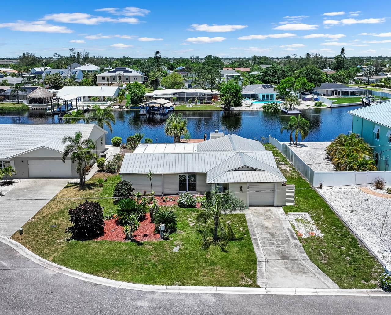 Enjoy the Florida waterfront lifestyle in this beautifully updated 3-bed, 2-bath, 1-car home located off a secluded and serene CUL-DE-SAC with NO HOA/CDD or rental restrictions! The Ruskin Inlet feeds into the Little Manatee River, providing unobstructed access all the way out to Tampa Bay! METAL ROOF, mature landscaping, IMPACT WINDOWS, covered front porch, COVERED/SCREENED LANAI, shed, OPEN DOCK: and that's all before stepping inside. NEW is the word for the interior of this coastal cottage, with ALL NEW APPLIANCES, NEW TILE FLOORING THROUGHOUT for easy cleaning, and a NEW HOT WATER HEATER! Enter into the living/dining room and move on into the RENOVATED KITCHEN, with its GRANITE COUNTERTOPS, closet pantry, BREAKFAST BAR, and all new STAINLESS STEEL appliances. The Family Room features a WOOD-BURNING FIREPLACE and is positioned between the primary suite and the secondary areas of this SPLIT-BEDROOM layout. Featuring a WALK-IN CLOSET and completely updated EN-SUITE BATHROOM with GRANITE countertop single-sink vanity and SHOWER STALL, this spacious bedroom is sure to delight. Both secondary bedrooms include ceiling fans and built-in closets, and are separated by the updated secondary bathroom with its GRANITE countertop single-sink vanity, tub/shower combination, and convenient hallway linen closet. The water view can be enjoyed from so many angles within this adorable home, but it's a real treat from within the large screened lanai or while dangling a fishing pole from the dock. This property is situated with easy access to US-41 and I-75, offering a blend of waterfront living while remaining in proximity to Tampa, St Pete, Bradenton, and beyond.