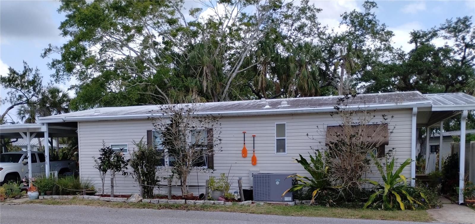 TWO BEDROOM, 1 1/2 BATHROOM MOBILE HOME IN ACTIVE 55+ COMMUNITY. This creek-side property is a gardeners delight with landscaped flowers and trees. It features a large living room, ample storage throughout the home, central a/c, membrane roof, & all appliances included. Both bedrooms have en suite bathrooms. Enjoy the shady, screened side porch, water view, and the double carport. SUGAR CREEK ESTATES is a resident run co-op. Amenities include a clubhouse, pool, shuffleboard, and plenty of activities during the winter season. Enjoy this community's proximity to the River Links Golf Course and the Braden River. HOA FEES of $550 each quarter include internet, cable, water, sewer, trash, & grass mowing. A CREDIT SCORE OF 750 is required to purchase in this community. This home is being sold unfurnished. Sorry, this is not a dog lot.