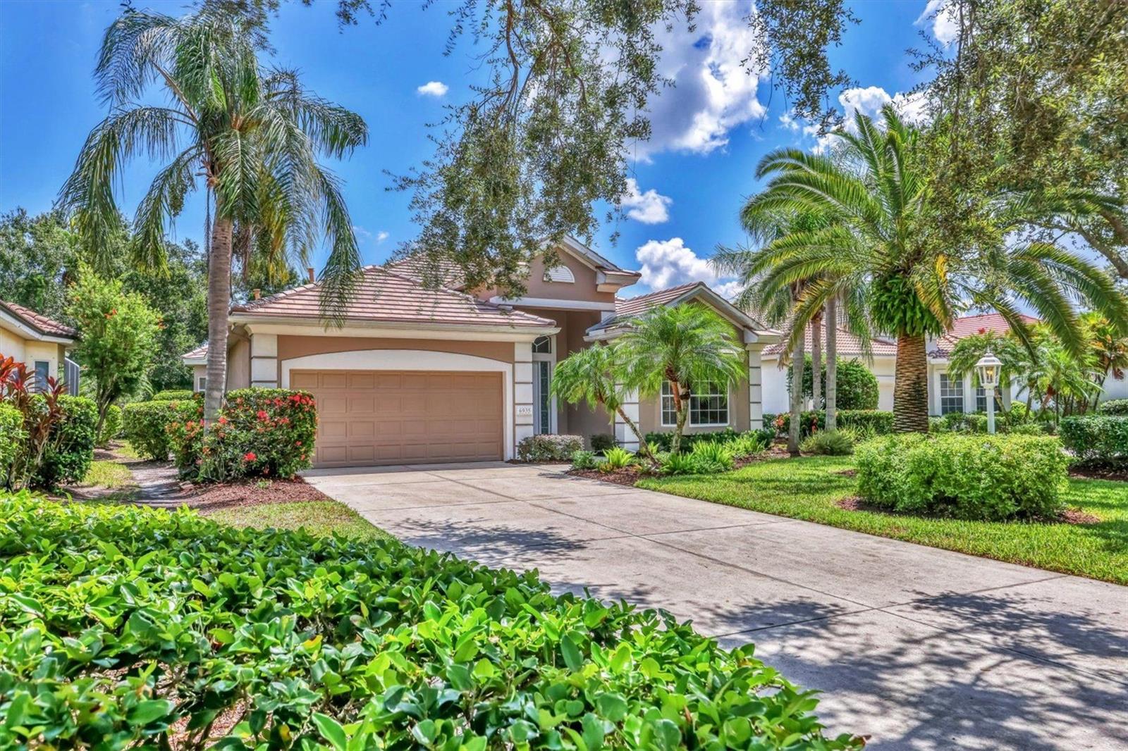 Timeless design and a floorplan that never goes out of style await in the Lennox Gardens enclave of the highly sought-after University Park Country Club. Set on a private lot with mature landscaping, this beautifully maintained home offers refreshed curb appeal and a welcoming covered front entry. NEW TILE ROOF (July 2025) and new luxury vinyl plank flooring (July 2025). Soaring 10-foot ceilings and abundant natural light create a bright, airy atmosphere. The spacious great room seamlessly connects to the formal dining area and a well-equipped kitchen with a breakfast nook and a charming window seat. Sliding glass doors open to a covered and screened lanai overlooking the heated pool with a soothing fountain feature. Private, lushly landscaped backyard, ideal for relaxation or entertaining. The primary suite features a tray ceiling, direct lanai access, large walk-in closet, and an ensuite bath with dual vanities, soaking tub, walk-in shower with frameless glass, and a private water closet. Two additional bedrooms are tucked behind pocket doors for added privacy and share a full bathroom. The third bedroom, with French doors, is perfect as a den or home office. Additional features include: whole-house water treatment system, window treatments, interior and exterior paint (2022), laundry room, and a two-car garage. Ready for immediate occupancy, this home is located in one of Florida’s top-rated golf communities. The Lennox Gardens enclave offers its own private amenities, including a community pool and spa, plus fitness room. University Park Country Club offers 27 holes of championship golf, tennis, pickleball, croquet, state-of-the-art fitness center, and a vibrant social scene. Residents here enjoy the Region’s popular country club lifestyle while being within close proximity to downtown Sarasota, shopping, dining, entertainment, beaches, SRQ International Airport, and I-75. Live the exceptional lifestyle you’ve been waiting for on Florida’s Gulf Coast.