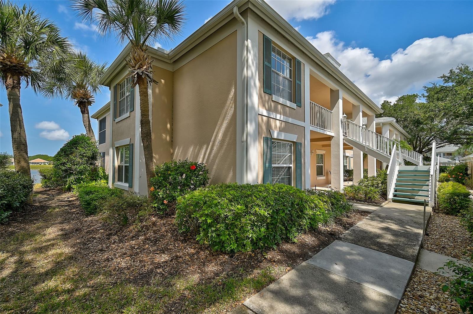 $10,000 PRICE IMPROVEMENT! Welcome to your Florida oasis! Situated on the coveted FIRST FLOOR and boasting 2 bedrooms, 2 bathrooms, a den, and a detached garage, this END UNIT with a LAKE VIEW offers the perfect blend of comfort, convenience, and captivating views. The spacious layout of the condo creates an inviting atmosphere, ideal for both relaxing evenings and entertaining guests. Discover the charm of wood cabinets and wood flooring in the kitchen, adding warmth and character to the heart of your home. The large primary bedroom showcases a gorgeous lake view as well. Primary bathroom features a shower and comfort-height counters, enhancing accessibility and comfort for everyday use. The inside washer and dryer make laundry day a breeze. Savor a panoramic view of the lake from the comfort of your glass-enclosed lanai. Perfect your swing on Peridia Golf & Country Club's 18-Hole Executive Golf Course. Cool off on hot summer days with a refreshing dip in your choice of two community pools. Dance the night away to live music at the country club's Friday night events or unwind with a tropical drink at the tiki bar. Engage in a variety of activities such as PICKLEBALL, tennis, mahjong, poker, and bowling, offering entertainment for all interests. Enjoy the convenience of nearby amenities, including shopping centers, restaurants, and recreational facilities, all within easy reach. Contact us now to schedule a private viewing and experience the beauty and tranquility of this property!