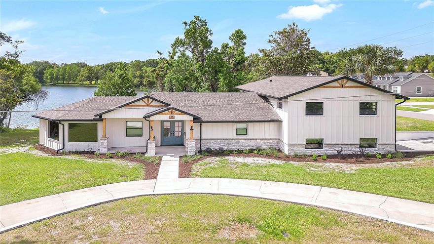 One or more photo(s) has been virtually staged. Don’t miss your opportunity to own this stunning lakefront home in the beautiful city of Apopka. This fully renovated 5-bedroom, 4-bathroom residence perfectly blends modern luxury with serene lake views. Step inside to discover an open-concept design highlighted by tongue-and-groove ceilings, custom cabinetry, and quartz countertops. The spacious kitchen features an oversized waterfall island and a convenient butler’s pantry, offering both style and functionality. New luxury vinyl flooring flows throughout, complementing the home’s high-end finishes and creating a warm, inviting atmosphere. Enjoy cozy evenings by one of the two electric fireplaces—located in the family room and primary bedroom. Designed for everyday convenience, the home includes two laundry rooms, a large deck for outdoor entertaining, and a two-car garage with a sleek new epoxy floor. Major upgrades include a brand-new roof, dual HVAC systems with new ducting, updated insulation, a full electrical and plumbing overhaul, and a new water heater. Move-in ready and perfectly situated near shops, restaurants, and major roadways including the 429, this home offers the ideal blend of luxury, comfort, and location for easy access to all of Orlando’s top attractions.