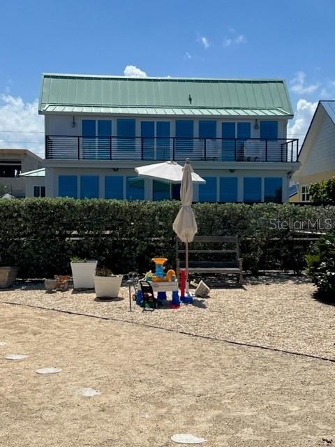 Oceanfront Cape Cod style renovated Seafarers Cottage. The Renovations in 1997 and 2014 added square footage, and is designed to be in keeping with the 1930s style. CENTRAL BEACH LOCATION ONLY 2 BLOCKS TO SHOPS, DINING, GROCERIES. Spectacular direct ocean views from most rooms and master bedroom. Furnished house features heart pine hardwood floors with white, plank-wood & beam ceilings and plantation shutters on every window. remodel & decor (2013-2014) included new metal roof, new vinyl siding, tropical landscaping, plantation shutters throughout. New washer & dryer 2021. Renovation also included new saltwater heated pool & spa on enormous 50â-40â foot Brazilian IPE Dec. Ocean-front deck also features table-top gas fire pit, Large Green Egg grill, and outdoor shower. Huge 22x23â foot Master Bedroom upstairs has vaulted ceilings and multiple sliding glass doors to a private, 34â foot ocean-sunrise-view deck. Large master bath features spa tub, private shower, bidet, walk-in closet, laundry closet, and glass sliding doors to private master oceanfront deck. Two additional beautifully appointed bedrooms and additional bathrooms located on the main level downstairs. Short Term Rental Zone with Excellent, professionally managed vacation-rental history to generate income! ;Water: City