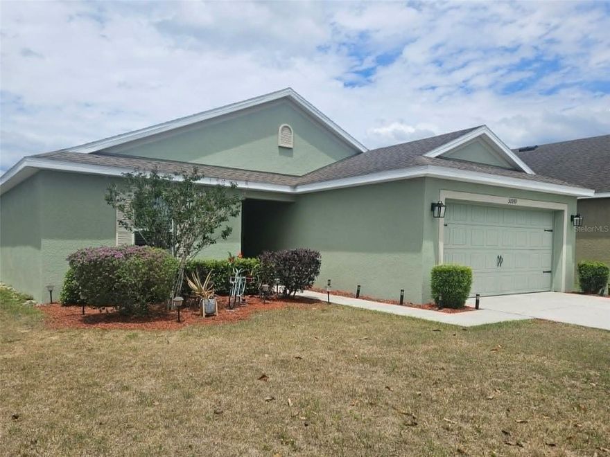 GOLF COURSE COMMUNITY. NEWLY REMODELED HOME. UPGRADED FLOORS AND LIGHTING. This freshly updated 2017 3-bedroom, 2-bathroom, 2-car-garage golf course home is in mint condition and move-in ready. It was just updated in 2026 with new paint both inside and out, freshly polished wood flooring, new carpeting, some newer lighting and fixtures, a new brick patio, freshly updated landscaping, and new epoxy garage floor. The open design of the kitchen and living area with their light, neutral colors maximize usable floor space in this home and help create a bright and cheery interior. The split bedroom plan offers a large master suite on one side with two secondary bedrooms on the other. The open eat-in kitchen offers granite countertops, hanging decorative lighting, a breakfast nook, and countertop seating for the whole family. Large, separate front room can be used as a formal dining room, home office or family TV room. Home has a nice rear view of the fairway yet is located with a long setback from the tee box area, making it ideally located from any line of play. Upgraded flooring and decorative fans and lighting throughout the home from the original builder’s grade add a lot to the look and appeal to this home. Sprinkler system with timer and zones. Refrigerator is not sold with home; seller concession for a new frig with the right offer. Sherman Hills golf course community hosts a community center with swimming pool and tennis court, and the golf clubhouse with bar and lounge, pro shop, carts, practice range and putting green right next door. Enjoy an affordable Florida luxury lifestyle with a host of social and recreational amenities right in your own neighborhood. Low HOA fee, No CDD fee. Pets are welcome.