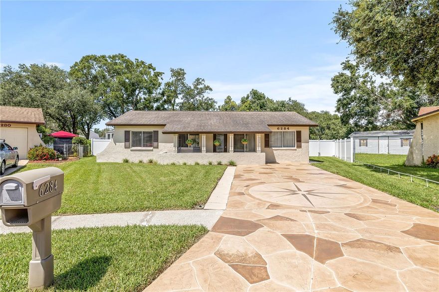 The backyard and garage space you’ve been searching for! Welcome to this beautifully maintained home in a rare equestrian and golf cart friendly community of Pinellas Park. Sitting on an oversized 0.27-acre lot, this property boasts an expansive irrigated yard with lush landscaping, perfect for entertaining, gardening, or even adding a pool.

A standout feature is the massive 24x36 detached garage, large enough to accommodate up to four vehicles. Complete with electricity and A/C, it’s ideal for a workshop, craftsman’s retreat, storage, or even the potential to convert into a guest or in-law suite.

Inside, the inviting open floor plan features a spacious living room flowing into the updated kitchen with a striking granite island and stainless steel appliances. Originally a 4-bedroom, the owners opened up the primary suite for added space, with the option to convert it back if desired. A split floor plan provides additional privacy with the third bedroom and half bath on the opposite side of the home.

Fresh paint, meticulous care, and charming curb appeal set the tone. The unique paver driveway has been painted and sealed, and the welcoming front porch is the perfect spot for morning coffee. Out back, French doors lead to a large screened porch and extended patio overlooking the expansive yard.

This property combines comfort, outdoor living, and rare garage space—don’t miss the chance to make it yours!