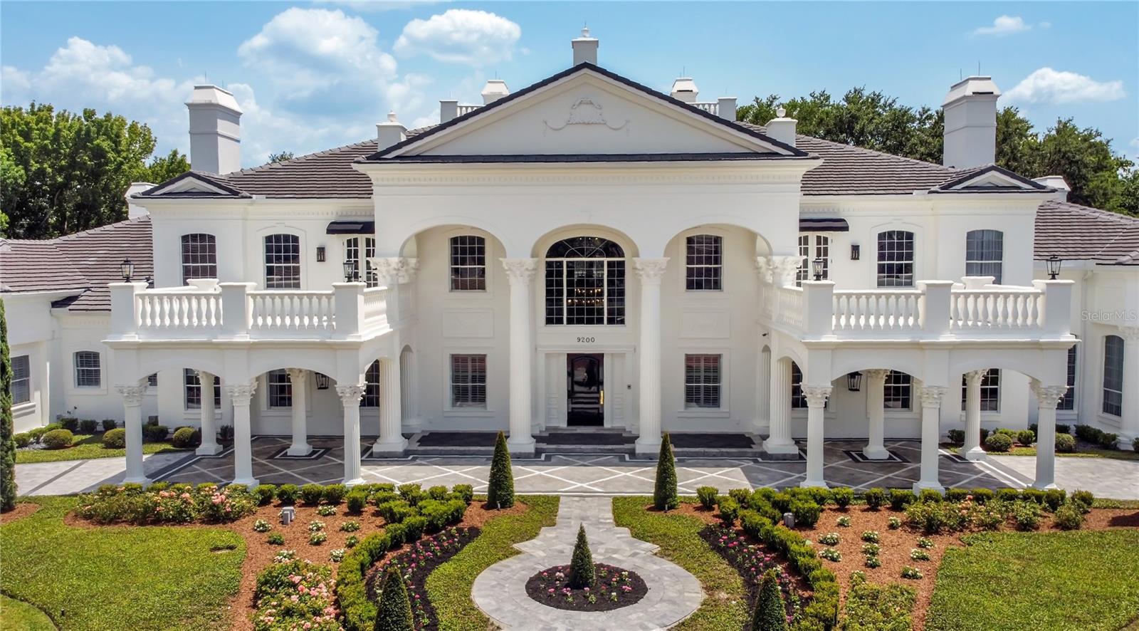 This incredible estate known as 'Bentley Hall' sits on a massive 2 Acre lot located in the heart of Central Florida just minutes from Walt Disney World and Universal! World class resorts, shopping, golf and restaurants are abundant in this area as well as all of the theme parks, however as soon as you drive through the 24 Hour Monitored Security Gate you will feel like you have entered your own private oasis. It is located within the sought after Bentley Park community within Bay Hill in the Dr Phillips area. This home boasts over 20,000 sqft under air and is being sold ***FULLY FURNISHED*** The entire home underwent an extensive and complete renovation during the past 2.5 years with the final work finishing early in 2022. Bentley Hall was redesigned, expanded & reconstructed with no expenses spared & with each construction and design decision carefully considered by a team of professionals. In additional to the full cosmetic remodel, all major systems were also updated including new roofs on all structures, new Hvac systems throughout, new septic systems, new tankless hot water heaters throughout, new insulation throughout, new main breakers and panels which were upgraded to 1000amps, new wells and irrigation, all new pool systems inside and out, including redundant heaters and auto top off systems and much more! The Bentley Hall design team has delivered a truly impressive Modern Transitional design allowing this immense estate to still feel warm & inviting while embracing the large size of all areas of this home. A rare & incredibly sought after aspect of this home is a full indoor SPA with access from the main hall as well as the master bath & featuring a sauna, a steam room, a 13' wide Jacuzzi with therapy jets, a guest changing area, a waterfall art feature, a built in bar, attached full bath, as well as an indoor daybed & massage table area & a dedicated outdoor relaxation lanai with swing beds & a fire feature. In addition to all of the living quarters you would expect to find in an estate like this, there is also a fully equipped gym, a movie theater that seats up to 20 w/ reclining beds, theming and a concession and ice cream bar area, state of the art AV equipment, a large den or yoga area, a gallery overlooking a cigar terrace area with adjacent bar which leads to a large room currently dedicated to a Golf Swing simulator, a secondary laundry area a back kitchen, bird aviary, a 25 year old producing citrus and tropical fruit grove, a turfed sports/play area, and much more. The Primary bedroom area takes up one full wing of the house with dual vanities, dual closets and dual private commode areas, lounging areas, direct spa, gym and primary garage access. The upstairs has a large family room area & 4 Ensuite bedrooms 3 of which are fully themed and one which is an incredibly luxurious suite perfect for family or Super VIP Guests. A few notable design features include book-matched marble wall slabs in various areas, intricate multi-layerd moldings throughout the home, custom Busby cabinetry throughout including bathrooms and closets, Sicis glass tile and custom glass doors, full Lutron lighting & Savant automation throughout the entire property, level 5 drywall finish, marble entrance and parking area, a 1 of 1 French chandelier, accordion glass doors connecting the great room to the exterior lanai, custom lighting, furnishings & decor throughout. There is also detached 2 bed, 1 bath **GUEST HOUSE** house that easily sleeps 6.