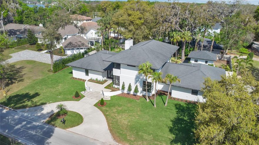 Step inside this beautifully updated home where clean lines, soaring ceilings, and two-story windows fill every corner with natural light. A floating staircase makes a stunning first impression, while the spacious family room with its cozy fireplace is the perfect spot to gather with friends and family.
The open living and dining room features built-ins with floating shelves, and the gourmet kitchen is sure to impress with custom cabinetry, waterfall quartz countertops, luxury appliances, a natural gas cooktop, and a walk-in pantry—everything you need for everyday living or hosting.
Your primary suite feels like a retreat with two walk-in closets, a spa-like bath with a freestanding tub, and sleek custom cabinets. Upstairs, two bedrooms include built-in desks and charming corner windows—perfect for a reading nook or window seat. You’ll also find a first-floor guest suite, a private office with pool views, a 3-car garage, and a spacious attic for storage.
The resort style backyard was designed for fun and relaxation. Enjoy the heated pool and spa, an entertainer’s bar, and even space to park your boat. The poolside casita with kitchenette is the ultimate bonus space—ideal as an in-law suite, game room or man cave.
Stroll or golf-cart your way to cafes, shops or the local brewery. Spend weekends at town parks, tennis and pickleball courts, or out on the world-famous Butler Chain of Lakes. With no HOA dues, tree-lined streets, and the peace of mind of a dedicated police department, Windermere combines natural beauty, community charm, and everyday convenience.