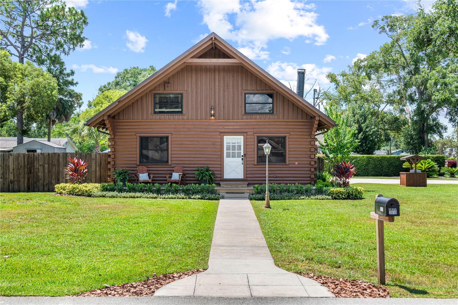 Conveniently located to all Central Florida locations and attractions, 15 minutes to Maitland/Winterpark, 22 minutes to downtown Orlando, and 30-40 minutes to the Disney Theme parks. This home is in Seminole County and zoned for Seminole County top rated schools. This beautiful Log Cabin home is situated on a .26 corner lot, features 2 bedrooms, 2 bathrooms plus a loft area! The home and property have been meticulously cared for and also features a 2 car garage with extra storage space, 16’x14’ fully insulated shed/office, 2 other storage sheds all fenced in for privacy with a 10 foot gate should you need to pull a boat or RV in the backyard. The home has lots of updates and custom features. When you walk into the home, you are drawn into the great room by the high vaulted pine tongue and groove ceilings, wood burning stone fireplace and an open floor plan leading to the kitchen. The kitchen has beautiful wood cabinets, concrete countertops, stainless steel appliances, an island and a custom built coffee bar. Both the island and the coffee bar have butcher block countertops. Right off of the kitchen, is a spacious laundry room with upright cabinetry for storage. On the ground floor, there is also a spacious bedroom and bathroom(full renovation in 2022). When you walk upstairs, the handrails and steps are all beautiful pine. Once upstairs, you will be in the loft flex space. This space was used as an office by the previous owners but also had a full sized bed in the flex space to be used for guests. The upstairs bedroom and bathroom were completely renovated in 2023. The master bedroom renovation included all new drywall, luxury vinyl flooring, new ceiling fan, and mirrors. Not only is the inside amazing and completely move in ready, wait until you see the outside! In 2024, all new St. Augustine sod was installed and the landscaping was professionally redone. The yard has an irrigation system and an irrigation well. In 2024, a brand new 16’x14’ shed was installed. This shed is fully insulated and used as an office. It has luxury vinyl linoleum, tongue and groove pine ceiling with a mini split air conditioner. In 2020, the concrete driveway was replaced. The roof was replaced in 2019 (permitted in 2018). The front porch has all new wood deck boards replaced in 2024. It has a sitting area with 2 rocking chairs (these chairs convey with home) for you to enjoy the beautiful landscaped yard! The back yard also has a deck and all wood was replaced in 2020 with 2x6 pressure treated wood. The back yard has a gas fire pit area with 4 Adirondack chairs and a high top teak table and 4 stools (these items convey with the home). The backyard is an oasis with river rock in all of the landscaped areas and concrete sidewalks leading to the outside spaces and sheds. The home has Govee lights on 3/4 of the home that light up in the evening. The property also has deeded access to Bear lake with access to 3 separate recreation areas for beach/swimming, fishing and boat dock. To access these recreational areas, you are required to join the Paradise Community Club Inc., annual dues are $100 annually. The home has a well. The well bladder and pump were replaced in July of 2017. The home also has a septic system. The drain field was replaced approximately 15 years ago and was recently pumped in June of 2025. All window treatments convey with the home. This move in ready home is a must see!