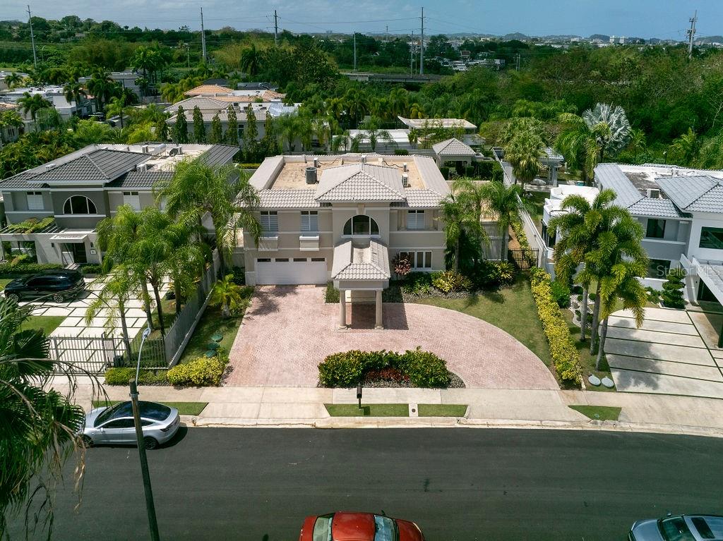 Welcome to Palma Real Estates – Luxury Redefined
Experience unparalleled luxury at Palma Real Estates, a distinguished residence that defines sophisticated living. This exquisite home, boasts 5 bedrooms, 4 full bathrooms, and 2 half baths, offering both elegance and comfort.
Spanning approximately 5,400 square feet of gross living area on a 1,200-square-meter lot, this grand estate welcomes you with a stunning entrance foyer leading to beautifully designed living spaces. The first floor impresses with a formal dining room, a spacious family room, a formal living area, and a casual dining space. At the heart of the home is a gourmet Poggenpohl kitchen, featuring high-end appliances, a walk-in pantry, and top-tier finishes.
Step outside to your private oasis, complete with a covered terrace, an inviting swimming pool, a gazebo with a half bath, and lush green surroundings—ideal for relaxation or entertaining.
The luxurious master suite is a true retreat, featuring an opulent en-suite bathroom with double sinks, a jetted tub, a walk-in shower, and a makeup vanity. A spacious, climate-controlled walk-in closet with a secure locking jewelry closet completes this magnificent space.
Additionally, the property offers a junior suite with its own en-suite bathroom and walk-in closet, ensuring privacy and comfort for guests or family members.