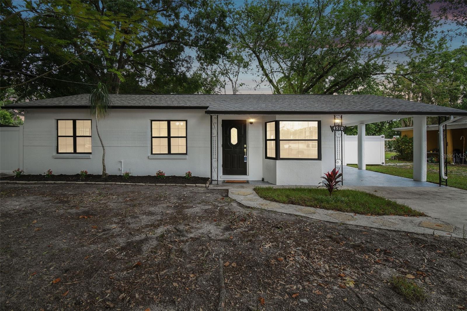 Come and take a look at this recently renovated home, where you'll find a tastefully designed interior that uses bold color contrasts. The living room features a cozy fireplace, creating a warm, relaxing atmosphere. The residence includes three comfortable bedrooms and two bathrooms. The house has a NEW ROOF, NEWER AIR CONDITIONING, NEW STAINLESS STEEL APPLIANCES, PORCELAIN FLOORS THROUGHOUT, NEW LIGHT FIXTURES, NEW FAUCETS, AND A NEW VINYL FENCE. The kitchen is well-equipped and features a modern island with an attractive waterfall-style countertop that blends functionality with aesthetic appeal. The interior is filled with natural light pouring in through large windows, enhancing the overall ambiance of the living spaces. The bathrooms are a luxurious experience, with glass-enclosed showers, stylish tilework, and elegant gold finishes. The backyard is spacious and offers plenty of room for outdoor activities, with a tree providing shade and privacy. The home is located in the Wellswood neighborhood, offering easy access to many nearby amenities. Wellswood Park is an incredible neighborhood in Tampa Bay that provides fantastic access to everything the city has — from the International Mall and the airport to Gulf beaches, surrounded by amazing restaurants, the Bucs stadium, the Tampa Zoo, Busch Gardens, and every new development in the city of Tampa.