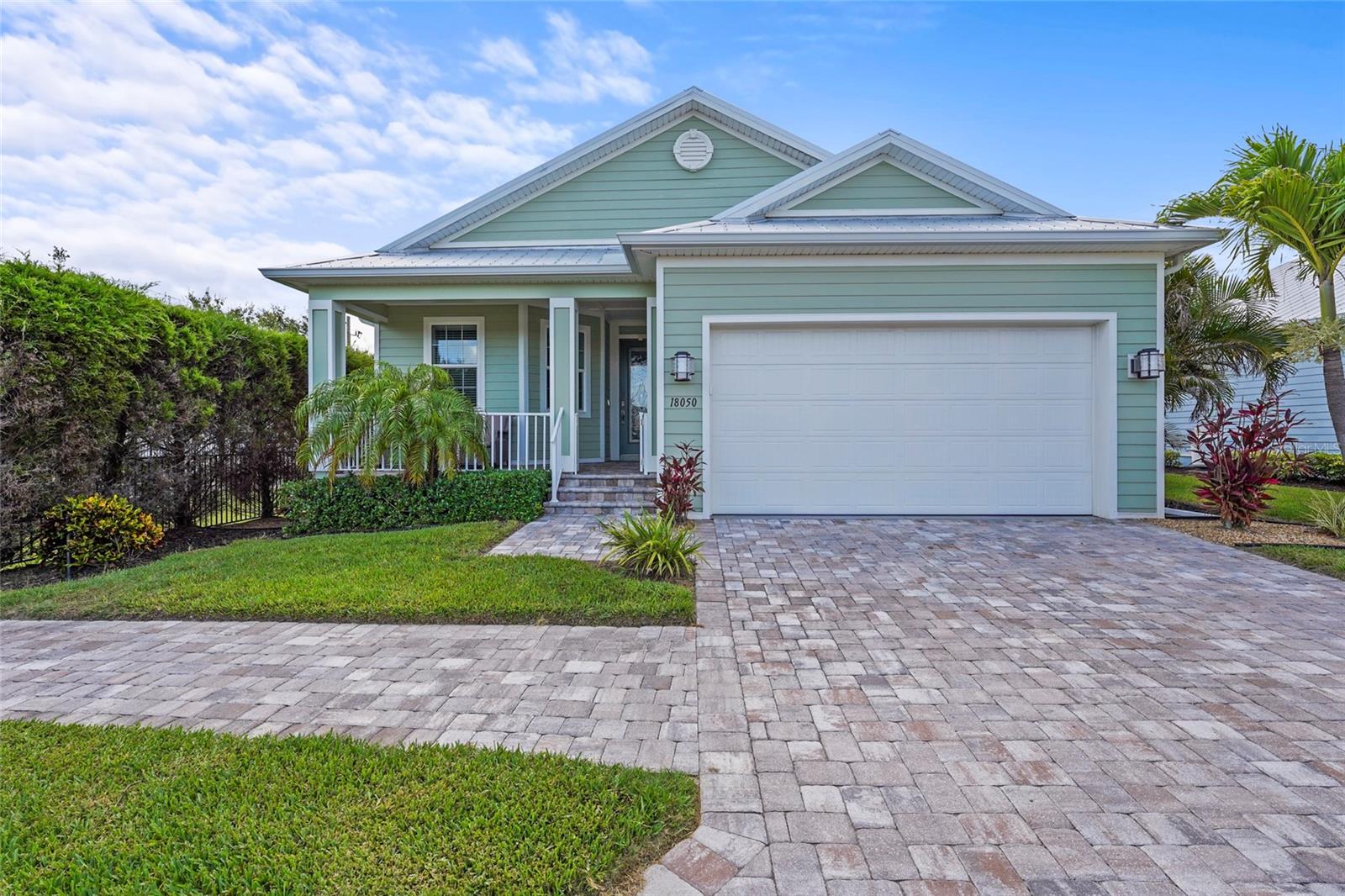 Welcome to The Cottages of Curry Creek, a hidden gem nestled in a small gated community offering direct Gulf access and low-maintenance coastal living. This Key West-style home features 2 bedrooms, 2 bathrooms, plus a versatile den currently used as a third bedroom—perfect for guests or a home office. Step inside to an inviting open floor plan where 10-foot tray ceilings, crown molding, and canal views elevate the spacious great room. The kitchen is equally impressive, boasting 45-inch wood cabinetry, granite countertops, and stainless steel appliances, all designed with both function and style in mind. The private den features glass doors and engineered hardwood flooring, while the large owner’s suite offers peaceful canal views, a custom walk-in closet system, and an ensuite bath designed for relaxation. Built with quality in mind, this home includes fiber cement siding over concrete block construction, PGT hurricane impact windows, energy-efficient ¾-inch foam insulation throughout the attic and walls, and a durable metal roof built to withstand the elements. Step into your backyard oasis where a private dock with a 10,000 lb boat lift awaits, offering instant access to Curry Creek, Roberts Bay, and the Gulf of Mexico. With low HOA fees covering gated access, lawn care, landscaping, and irrigation, enjoy a truly carefree lifestyle. Ideally located just minutes from downtown Venice, Nokomis Beach, the Legacy Trail, and an array of dining and shopping options—this is waterfront Florida living at its best.