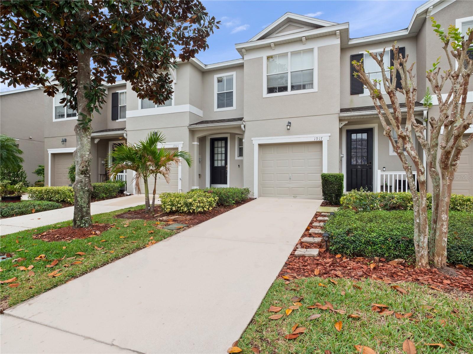 Welcome Home! As you enter this vibrant community, you'll immediately notice the exceptional amenities available to residents. Pull into your private garage and step into a grand foyer, complete with a convenient guest bathroom.  This beautifully maintained home features a spacious kitchen with 42-inch cabinetry, a modern backsplash, and plenty of room to add an island or breakfast table. Enjoy both a cozy eat-in area and a charming breakfast nook that overlooks the expansive backyard. A formal dining area provides the perfect space for hosting meals and gatherings. Full of thoughtful touches, this home includes a surprise bonus: a second living area located in the primary bedroom—ideal for a reading space, TV lounge, or home office. The primary suite also offers a versatile enclosed space that can be adapted to fit your lifestyle. Located at 1917 Compass Flower Way, this townhouse puts you close to everything! Enjoy convenient access to shopping centers, restaurants, theme parks, major roadways, and Orlando International Airport. Whether you're a daily commuter or weekend adventurer, this central location makes getting around easy. This immaculate, move-in ready home is just waiting for you. Schedule your private tour today!