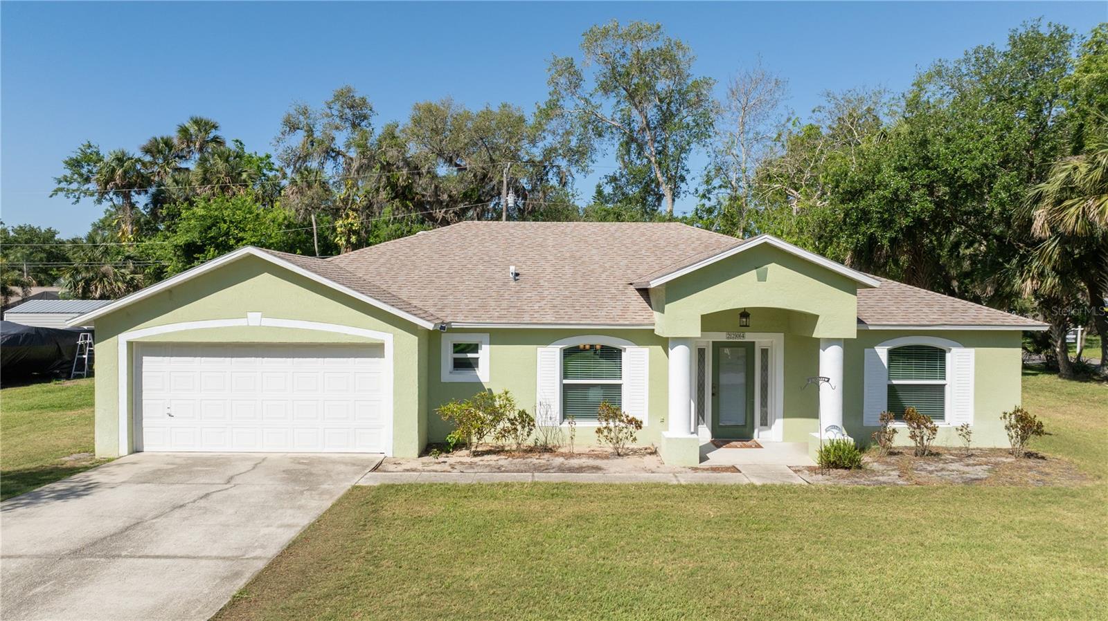 Welcome to this beautifully updated 4 bedroom, 2.5-bathroom home, offering the perfect blend of comfort, style, and convenience. Situated on a rare 4-lot corner property, this home provides plenty of space both inside and out- Ideal for families, entertaining, or simply enjoying a relaxed lifestyle. Step inside to an inviting open floor plan featuring luxury vinyl flooring throughout for a modern, low-maintenance look. The eat-in-kitchen and dining combo is perfect for casual family meals or hosting guests, flowing seamlessly into the spacious living area. Enjoy year-round living with the brand new 35ft x 14ft screened room added in 2023- the perfect spot for morning coffee or evening gatherings. Major upgrades include new roof (2019) and new windows (2019), giving you peace of mind and energy efficiency for years to come. Located close to local elementary schools and Whistle Stop Park, this home also offers quick access to I-95, is just 10 minutes to the Intracoastal Waterway, and a short 20-minute drive to the beach. It's the perfect balance of quiet suburban living with all the conveniences nearby. Don't miss this opportunity to own a spacious, move-in ready home with room to grow!