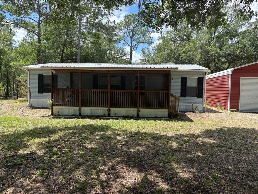 Beautiful wooded acreage properties like this are hard to find! Situated on 4.03 scenic acres with walking trails and a seasonal pond, this well-maintained 1989 manufactured home offers privacy, peaceful surroundings, and move-in ready condition. Home features 3 bedrooms, 2 bathrooms, and 1,232 SF of living area with fresh interior paint, new carpet, and vinyl flooring throughout. Enjoy the large screened front porch overlooking the tranquil setting. Kitchen has been updated with a new range, refrigerator, and dishwasher. Bathrooms feature some upgrades including a beautifully tiled walk-in shower. Additional improvements include a new water heater, central A/C, serviced well with new pump, and roof permitted in 2017.

Outside you’ll find a huge 24x32 detached garage built and permitted in 2019, plus an additional storage shed offering plenty of room for vehicles, workshop space, or extra storage. Property is serviced by private well and septic and offers endless possibilities for enjoying country living while still being convenient to town.  Schedule your private showing today before this one is gone!
