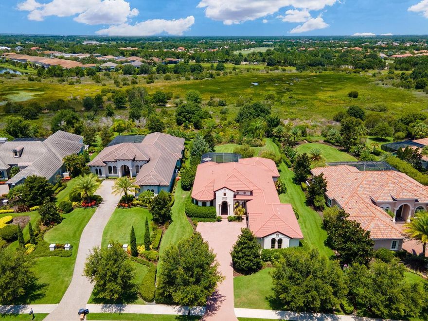 Named the “best selling master-planned community for all ages in the country for 2021”, Lakewood Ranch offers an award-winning lifestyle that’s second to none. If you’ve yet to experience life on The Ranch, it will be an exhilarating one not soon forgotten. Located within one of Lakewood Ranch’s most desirable villages, the Lake Club features all the resources of a high-end resort in a Tuscan-inspired setting graced with Italian cypress, brick-paver roundabouts, and stone bridges over lakes. Backed by a nature preserve for the ultimate in privacy, this pristine, FULLY FURNISHED 3-bedroom, 3-bath home shows like new and exudes grace, grandeur and beauty. Within the 3,064 square feet of sophisticated modern elegance are 3 en-suite bedrooms, office/media room with built-ins, impressive great room with dramatic multi-tiered tray ceiling and stacked stone fireplace, spacious dining area, and stunning kitchen with 11-ft. island and all the luxurious bells and whistles any chef would appreciate. The beautiful outdoor living area offers a massive lanai with summer kitchen and heated pool/spa. The main bedroom suite has a wing to itself with seating area, dual walk-in closets, frameless shower with travertine design and soaking tub encased in stone. Additional amenities include solid wood core doors, travertine flooring throughout, 3-car garage, newer A/C (2020), newer pool heater (2020), a lush landscape accented with night lighting, and so much more. This custom-built home was finely crafted by Arthur Rutenberg Homes, one of most prestigious estate builders in the region known for their commitment to excellence and innovation in home designs. Thermostats, pool & spa, garage door, front door, landscape lighting, irrigation, ring doorbell, cameras, and security system can all be controlled remotely. -- The Lake Club affords its residents a grand clubhouse, a restaurant, two pools, a large fitness facility and tennis courts, all located within the Lakewood Ranch community where 40% of its 50 square miles is dedicated to recreation and open space. Lakewood Ranch is home to top-rated schools, a hospital, 60 clubs, a parks and recreation program, a sports league, 150 miles of multi-use trails, 9 community parks, 3 town centers, and a variety of stylish boutiques, theaters and international restaurants. It's a destination within a destination and a place for living your very best life.
