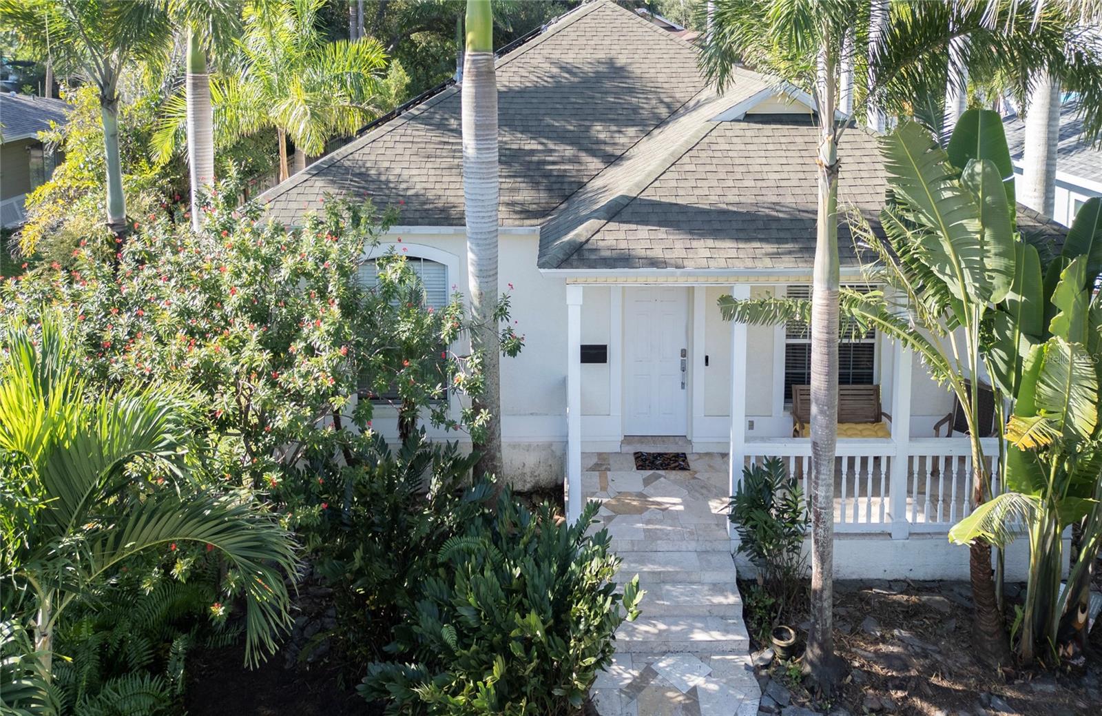 Welcome home to this beautifully designed and stylish three-bedroom, two-bath residence in the heart of NE St. Petersburg. NO WATER INTRUSION FROM STORMS. Built in 2003 and designed with an open, light-filled floor plan, this home is perfect for entertaining. The spacious living room flows into a large kitchen with granite tile countertops, walk-in pantry and laundry room off the kitchen and stainless steel appliances. The oversized master suite features French doors to the patio, a private sitting area, his-and-her closets (including a walk-in), and a luxurious bath with dual sinks, a garden tub, and separate walk-in shower. Additional highlights include custom bathrooms finished with marble and natural stone, wood and tile flooring throughout, indoor laundry room, alarm system, sprinkler system, and an oversized two-car garage with storage cabinets and an outdoor storage as well. There is even a private area on the east side of the house with concrete slab ready for your hot tub, with plumbing and electrical already installed. In front of the 2 car garage is an oversized parking pad that easily fits two more vehicles. The primary daily entrance is conveniently located at the rear, with alley access and newer homes lining both sides where neighbors frequently share a friendly conversation. Enjoy evenings on the front porch or private back patio surrounded by lush tropical landscaping and high-end royal and corkscrew palms. Just east of 4th Street, this ideal location puts you moments from restaurants, shopping, parks, and public boat ramps — with downtown St. Pete, I-275, Tampa International Airport, and the Gulf beaches only a short drive away. Don’t miss this opportunity to own an affordable home you can remodel to your specifications in one of the city’s most desirable areas! MORE INTERIOR PHOTOS COMING THIS WEEK!!!