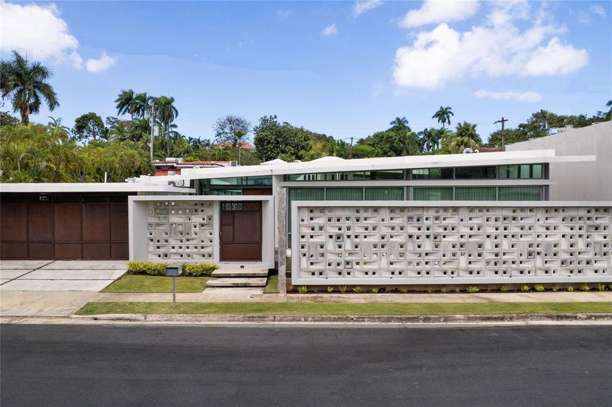 This magnificent estate is located on the renowned Meadow Lane in Garden Hills North, Guaynabo. It features 4 bedrooms, 4 full bathrooms, and 2 powder rooms, offering 3,400 square feet of interior living space within a total footprint of 5,500 square feet. Garden Hills is one of the most established and central high-end communities in the San Juan metro area, celebrated for its unique topography and large, private lots that feel like a tropical forest right in the middle of the city. Situated at address A5, this residence is a true private sanctuary featuring a sparkling private swimming pool surrounded by lush gardens and expansive green areas. The interior offers grand proportions and a seamless flow for entertaining, while the exterior provides a resort-like atmosphere with unparalleled privacy. Located in a secured neighborhood with controlled access, this home offers the perfect balance of luxury and convenience, sitting just minutes away from the island's most distinguished private schools and premier shopping destinations. CRIM: $2,189.88 annually | HOA: $178.50