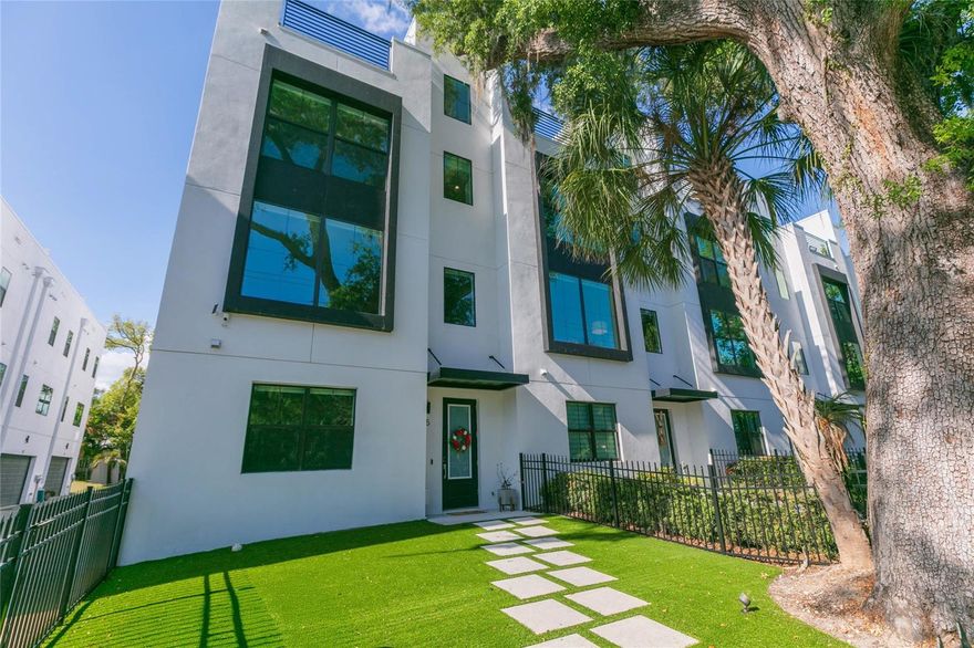 Contemporary living at its finest with over $100K in upgrades - meticulously maintained 4 bedroom plus office, 3.5 bath townhome with an oversized 2-car garage and huge open air rooftop terrace just steps from the tranquil Bayshore Boulevard and its miles of waterfront perfect for running, biking or leisurely strolls. The exterior architecture and craftsmanship is reflected in every detail, comprised of concrete block dividing walls and sound barrier impact windows & doors. Thoughtfully designed and move-in ready, this 2,744 sq. ft. residence constructed in 2022 combines thoughtfully curated design with comfortable indoor/outdoor living. Modern elegance plus functional design with all the bells and whistles top to bottom, including luxurious white oak hardwood floors throughout. This desirable end unit boasts an open floor plan featuring 10-foot high ceilings in the main living area and owners retreat accentuated by expansive windows framing calming views of trees while welcoming loads of natural light. Gourmet kitchen features Bosch appliances, quartz countertops, custom cabinetry and a large central island. A bright and private office or flex space sits conveniently adjacent to a stylish half bath - ideal for remote work or creative pursuits. Upstairs, the owner's retreat includes two generous walk-in closets and a spa-inspired bath with dual vanities, water closet and frameless glass shower. The turfed rooftop terrace is also lovely from sunrise to sunset, offering glimpses of Tampa Bay and ideal for relaxed weekend gatherings, sunset cocktails or evenings under the stars. Front yard is also turfed and fully fenced for any furry friends to frolic. Custom woodwork, designer lighting, personalized closet organizers, Haiku Big Ass Fans, you name it - no expense has been spared. Ideally located on Gandy Boulevard with convenient access to Bayshore Blvd, Hyde Park Village, MacDill Air Force Base, downtown Tampa, Tampa International Airport, major sports venues, an array of upscale dining, entertainment and of course shopping too. This home offers modern South Tampa living at its finest, enhanced by privacy, premium upgrades and custom details that set it apart. An unbeatable location with A-rated schools, also 100% high and dry for both Helene / Milton - worth every penny to call home!