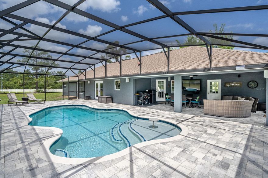 This 3 bedroom 2 1/2 bath block home sitting on 1.61 acres has everything you need including a beautiful new pool and detached garage/metal barn.  Home offers tile floors throughout with cathedral ceilings, open floor plan, granite counters, large master suite, exercise room, fireplace, and much more.  The master suite includes a large walk in closet, walk in shower, double sink vanity and jetted bath tub.  Step outside to the covered patio with built in surround sound overlooking the heated and cooled pool with screen enclosure and pavers.  Don't stop there because the property also has a 50x43 metal garage with 3 garage doors and room for 6 cars.  Great location for easy access to SR44, I-4, and close to beach.