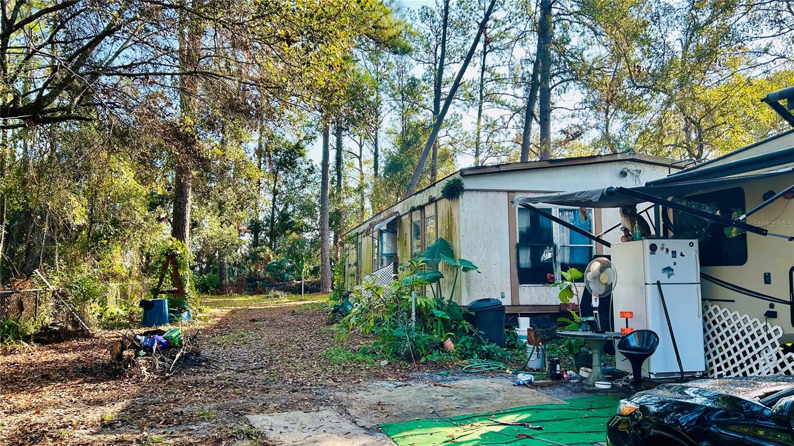 This property is well located, off US41 and Spring Hills Rd. Easy access to Suncoast Pkwy for easy commute to Tampa. Almost half acre, wooded and fenced. Electricity, well and septic already in the property, with no guarantees. There is a double wide MH 24x57 that has been abandoned for years, and some demolition has been started. Your imagination is the limit. Value is on the land. Being sold AS IS. *CASH ONLY*