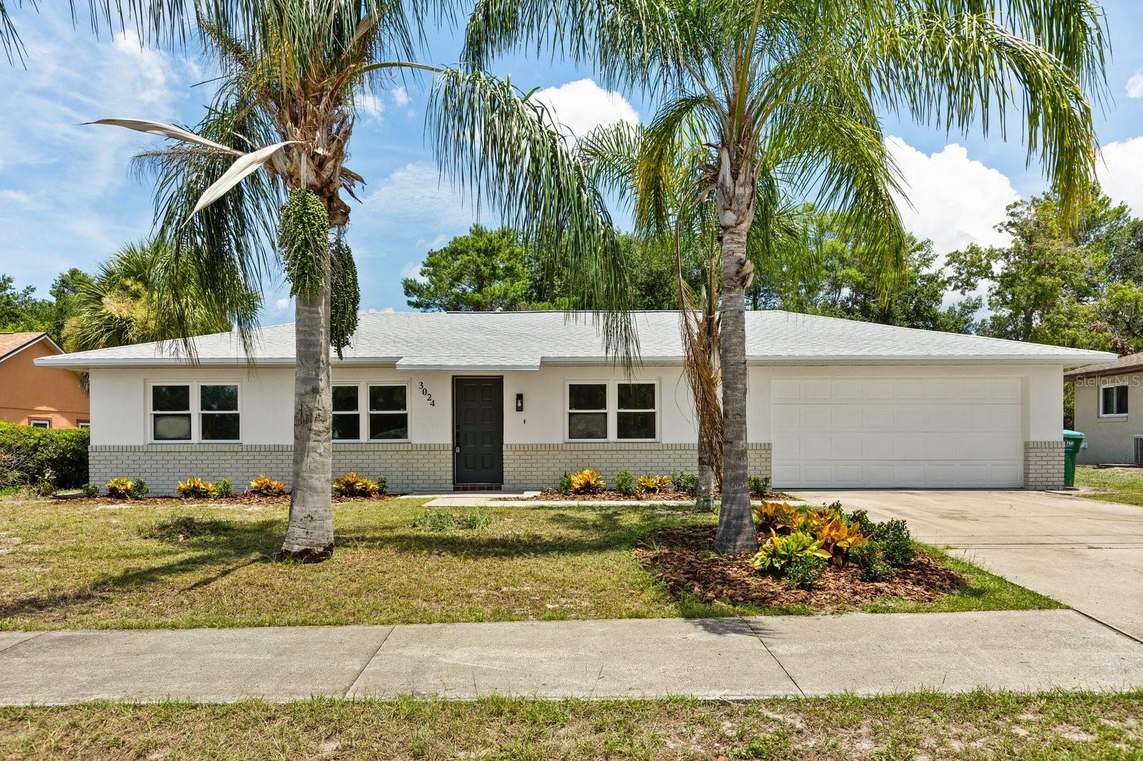 Beautifully remodeled 3-bedroom, 2-bath home featuring a modern split floor plan and stylish updates throughout. Inside, you’ll find brand new luxury vinyl plank flooring with NO CARPET, a stunning kitchen with quartz countertops and soft close cabinets and fresh interior and exterior paint. The home also includes a NEW ROOF (2025), new doors, and a screened porch overlooking a spacious backyard perfect for relaxing or entertaining. The two car garage offers an epoxy coated floor that looks offers durability and a polished look. This home is located just minutes from several local parks and recreation spots, including walking trails, playgrounds and open green spaces. You’re also less than five minutes from Publix, with beaches like New Smyrna and Daytona about 30 minutes away and Disney and Universal within a 45 minute drive.