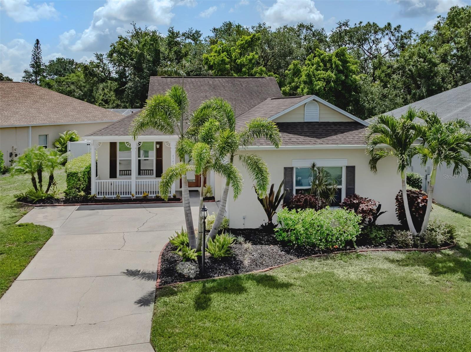 A charming three-bedroom, two-bath, desirable two-car side entry garage home in the heart of Lakewood Ranch is proudly presented. This beautifully designed home features an open-concept layout for modern living and entertaining. As you arrive, a sparkling lake adjacent to a walking path leads your eye toward an elegant front elevation on a sizeable corner lot. Enter through the contemporary lead glass double doors into a spacious living area bathed in natural light and complemented with 14-foot vaulted ceiling, columns, updated light fixtures, updated fans and arch details. The gourmet kitchen boasts stainless steel appliances with a natural gas range, quartz countertops with an under mount sink, designer tile backsplash, light wood cabinets, breakfast nook and a large island making it a chef's dream. Go outside to your private oasis, where a screened lanai and refreshing pool overlooks a lush privacy fenced backyard ideal for outdoor gatherings, play area, pet oasis or quiet evenings under the stars. The primary suite serves as a tranquil retreat featuring a luxurious en-suite bath with abundant closet space. The second and third bedrooms are generously sized with two individual hallway linen closets and share an updated bath with dual sink vanity, allowing space for family or guests. New aluminum impact windows were installed in 2025. In the community of Summerfield Village, you will enjoy a low HOA fee, access to top-rated schools, parks with over 150 miles of recreational and biking paths, dog parks, cultural events, shopping, golfing and dining. Only minutes to Interstate 75, downtown Lakewood Ranch, the UTC Mall, 13 miles to downtown Sarasota, and 19 miles to the world-renowned and recognized Siesta Key Beach. Experience an opportunity to own this exceptional property in one of Florida's sought-after neighborhoods, Lakewood Ranch. Immerse yourself in the rich culture, cuisine and tales that define this region. Your home and new adventures await you.