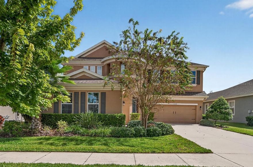 6307 Brevada Avenue | 5 Bedrooms | 4.5 Bathrooms | 4,278 Sq Ft | WestBay Madeira Floorplan

Built in 2018 by WestBay Homes, this Madeira floorplan offers 4,278 square feet of thoughtfully designed living space on a private conservation lot in the highly desirable community of Waterset. Located in Flood Zone X—no flood insurance required—this home combines modern design with practical functionality and custom upgrades throughout. The grand foyer features a soaring 24-foot ceiling, elegant staircase, and engineered wood-look vinyl flooring that flows throughout the main level. French glass doors open to the private office at the front of the home. The open-concept floor plan includes a formal dining room, kitchen eat-in area, flexible grand room, additional office, large second floor loft, and spacious family room with built-in surround sound and recessed lighting. The custom gourmet kitchen is the heart of the home, complete with upgraded cabinetry featuring enhanced organization drawers and pull-outs, a beautiful glass door highlights the oversized pantry, custom backsplash, quartz countertops, stainless steel appliances including gas cooktop and wall oven, and a large island with seating and dual-sided storage. A cozy coffee nook adds an extra touch of convenience, while custom lighting highlights the home’s modern finishes. A main-floor guest suite with full bath offers flexibility for a private in-law or multi-generational space. Multiple storage closets and under-stair storage provide exceptional organization options throughout the home. Upstairs, a large open loft creates the perfect secondary living space, with a split-bedroom layout for added privacy. The primary suite features dual walk-in closets and a spacious bath with dual vanities, a soaking tub, and a walk-in shower with floor-to-ceiling custom tile work. The upstairs balcony extends off the loft and offers quiet, peaceful views of the conservation area—ideal for relaxing or entertaining. The home’s rear lanai is pre-plumbed for gas and water, allowing for easy future installation of an outdoor kitchen or custom pool. Additional features include 8’ doors throughout, in-wall pest control system, dual garages with epoxy floors, and custom lighting inside and out. The Waterset community offers resort-style amenities including multiple pools, two fitness centers, basketball, tennis, and pickleball courts, walking and biking trails, dog parks, playgrounds, café, and community clubhouse. Conveniently located near shopping, dining, and major highways, this home provides easy access to Tampa, St. Petersburg, and the beautiful Gulf Coast beaches.