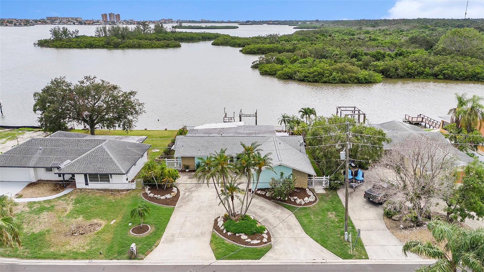 OMG Becky… LOOK AT THAT VIEW! Tucked away off Mile Marker 19 of the Intracoastal Waterway, this home is the DEFINITION of RESORT-STYLE LIVING—and it starts in Your Very Own Backyard. With absolutely NO rear neighbors, your Private OASIS opens up to SERENE Water, lush NATURAL Green space & an ever-changing display of Florida Wildlife. Imagine sipping your favorite beverage while DOLPHINS & MANATEES put on show, Stingrays make springtime appearances & Ospreys dive for dinner—ALL from the Comfort of Your Covered Patio. You'll enjoy a Front-Row seat EVERY SINGLE DAY! Otters, Raccoons & a variety of birds frequent the area, adding MAGIC to YOUR BACKYARD SANCTUARY!!!! And YES, you can literally fall asleep to the gentle sound of waves lapping against the shore. From the Primary Suite you can be in bed and still see all the Water action! LOCATION, LOCATION, LOCATION – this one has it ALL!
Situated in the desirable Oakhurst Shores community, this IN-LAND waterfront location gives you the Ultimate water views withOUT the intense seawall wear. Watch all kinds of Boats, Water Crafts, Kayaks & Paddleboarders float by—minus the heavy wave action. Composite dock with Wrapped Piers with Water & Electric on the dock. BOAT LIFT for easy water access. Fenced yard for your 4-legged companions. Sparkling POOL with WATERFALL—perfect after a day on the water.
REBUILT, REMODELED & MOVE-IN READY! Yes—this property did experience less than a foot of water during Hurricane Helene. But here's the good news: it was professionally Remediated & Rebuilt by a Licensed Contractor, & ALL permits are closed / finalized!!! Flood insurance approx. $3,000/year and transferable to new owner. STUNNING KITCHEN Remodel: QUARTZ countertops | TONS of Shaker-style cabinets | Composite sinks | WHIRLPOOL APPLIANCES built-in microwave / OVEN has AIR FRYER combo | Glass cooktop with hood | 2 garbage disposals | Beverage fridge | Endless cabinet & Counter space | 2 breakfast bars for entertaining or working on projects | Tankless water heater | BRAND NEW 4 TON 14.3 Seer AC COMPRESSOR & AIR HANDLER with 10year warranty on parts.
Additional Highlights: DOUBLE-PANE Windows throughout. PGT Sliding Glass doors installed 3 years ago... Main & flat ROOF REPLACED in 2017…Ceramic PLANK Flooring with Sealed grout (approx. 6 years old)...Updated Guest Bathroom. Both bedrooms feature Private en-suites, with the PRIMARY suite offering: 2 OVERSIZED WALK-IN CLOSETS, DUAL VANITIES, HUGE Walk-in SHOWER with 2 RAIN SHOWER HEADS you'll fall in love with!
LOCATION PERKS: less than 10 minutes to the Beach, Shopping, Parks & Bay Pines VA. 40 minutes to Tampa International Airport.
This isn’t just a home. THIS IS YOUR EVERYDAY VACATION, YOUR WATERFRONT ESCAPE, YOUR PERSONAL SANCTUARY. COME SEE WHAT IT'S LIKE TO LIVE THE DREAM—YEAR-ROUND.
