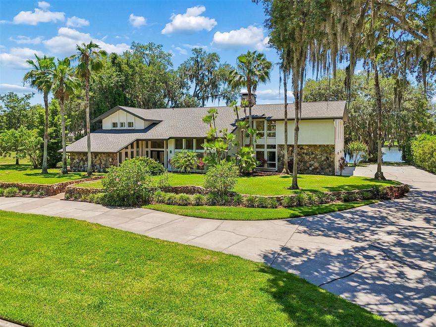 One or more photo(s) has been virtually staged. Set along the tranquil shores of Lake Taray within Avila, this exceptional lakefront estate presents a rare opportunity to own a true legacy property in one of Tampa’s most revered and ultra-private enclaves. Framed by towering mature trees and uninterrupted water views, the residence is a masterclass in contemporary architecture, where soaring volumes, refined materials, and seamless indoor-outdoor living create an atmosphere of understated sophistication. Dramatic 30-foot ceilings and expansive walls of glass draw natural light deep into the interiors, while floor-to-ceiling windows capture panoramic lake vistas from nearly every room, blurring the line between architecture and nature.
Thoughtfully reimagined in 2021 with continued enhancements, the home balances elevated design with effortless livability. At its center, a striking chef’s kitchen is appointed with an oversized gathering island, Viking and Miele appliances, stone surfaces, a 42-inch workstation sink, and a beautifully integrated wet bar designed for uncomplicated entertaining. The adjacent dining room, living room, and library unfold seamlessly beneath soaring ceilings, while double French doors open to the expansive lanai and resort-style saltwater pool, creating a fluid connection to the surrounding landscape.
The primary suite is conceived as a private retreat unto itself, complete with a fireside sitting room, spa-inspired bath, and dual walk-in wardrobes. Every space throughout the residence has been curated to evoke both comfort and quiet luxury, offering a lifestyle equally suited to intimate evenings and large-scale entertaining.
Avila is among Tampa Bay's most established and closely held addresses. Round-the-clock guard-gated security, resort-caliber amenities - parks, pickleball and basketball courts, a dog park, pavilion, and walking paths - and optional membership to the Avila Golf & Country Club, with championship golf, tennis, fitness, and dining, set the standard for the lifestyle this community offers. Downtown Tampa is twenty minutes away.
Waterfront estates of this standing in Avila rarely come to market. This is one worth knowing.