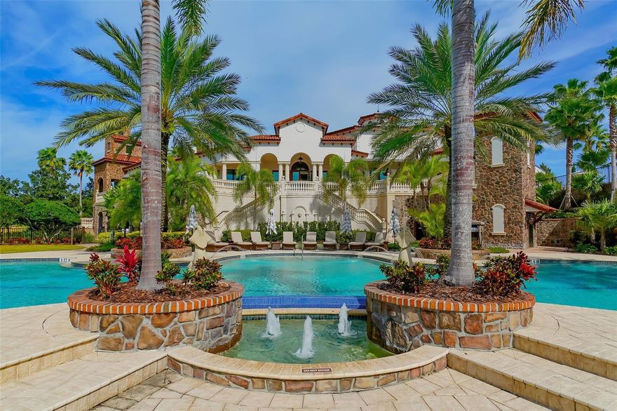 An exceptional expression of Florida luxury, this custom-built, Island-inspired estate by Anchor Builders enjoys an extraordinary setting with wide-open lake views, unmatched privacy, and no neighboring homes in front or to one side—offering a rare sense of space in the exclusive Lakeview Estates section of The Lake Club. Built in 2021 with hurricane impact glass and a whole-house generator for peace of mind, this refined expansion of the Marquesas floor plan offers nearly 5,400 square feet of thoughtfully designed living space with four spacious bedrooms, a private office with custom built-ins, an impressive bonus room, and split garages for four vehicles plus a golf cart. Rich hickory wood floors, intricate ceiling and wall details, and two gas fireplaces enhance the timeless interior, while zero-corner sliders create seamless flow to an extraordinary outdoor living area. The 50-foot saltwater pool and spa, surrounded by Shellock pavers, is paired with a full outdoor kitchen equipped with FireMagic grill, side burners, fridge, sink and bar offering a seamless extension of the home’s luxurious living spaces.  Inside, the professional grade kitchen is appointed with finely-crafted hardwood cabinetry, Sub-Zero and Wolf appliances, a generous walk-in pantry, and a wine bar complemented by a Sub-Zero wine fridge. Behind the scenes, high-end smart home technology manages lighting, motorized shades, security cameras, pool functions, and audio, while enterprise-grade Ubiquiti networking ensures flawless connectivity. Additional features include a two private water closets in primary en suite, mosquito misting system, three EV chargers, and a 14x14 air-conditioned interior Florida basement with refrigerator—perfect for secure storage or overflow pantry use. This is an extraordinary opportunity to enjoy a luxurious lifestyle in Lakewood Ranch’s most prestigious gated enclave. Residents of The Lake Club enjoy world-class amenities, including a guard-gated entrance, a vibrant clubhouse, a restaurant and bar, two resort pools, fitness facilities, sports courts, fishing, and scenic trails. Located in Lakewood Ranch, the nation's top-selling multi-generational community, this exceptional residence is just minutes from premier shopping, dining, top-rated schools, and the Gulf Coast's pristine beaches.