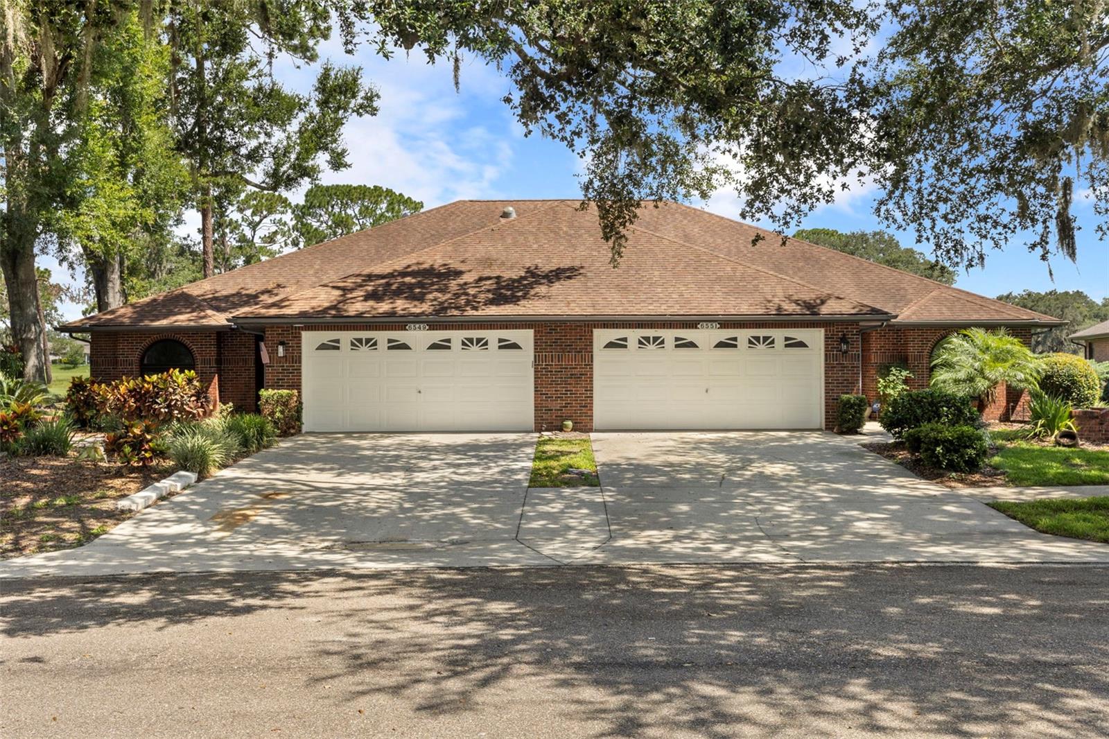 Beautifully renovated 2-bedroom 2-bathroom villa in Silver Oaks with stunning golf course views and a spacious 2 car garage complete with a finished floor, brand new opener, and washer and dryer closet with hookups. Inside this home offers luxury vinyl plank (LVP) flooring throughout, and a thoughtfully designed open-concept layout that is perfect for everyday living and entertaining guests. The thoughtfully designed kitchen features a large central island, brand-new kitchen appliances including a counter-height microwave for added safety, and a large kitchen pantry. Across from the kitchen island is a built-in bar area with a wine fridge - perfect for entertaining. The main living area impresses with vaulted ceilings, skylights that fill the home with natural light, and a stunning wood slat feature wall where a TV can be mounted over the cozy electric fireplace. Off the living room are French doors opening into the bright and airy Florida room offering additional living space overlooking picture worthy views of the golf course - perfect for relaxing or entertaining guests. This home offers two generously sized bedrooms and two beautifully updated bathrooms, including the spacious primary suite with dual sinks, and a walk in shower. Completely renovated in 2025, every finish in this home is completely brand new—making it truly move-in ready!