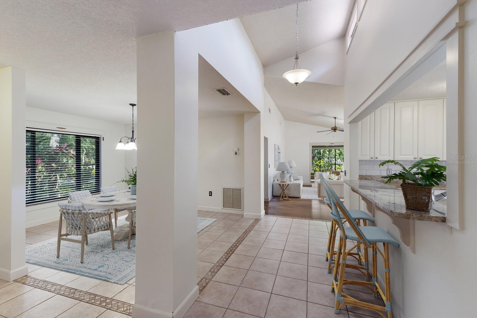 $7,500 PRICE IMPROVEMENT and a fresh new look! WELCOME HOME! Don't miss this opportunity to own your own slice of paradise on the West side of Bradenton, FL in the highly sought after community of Wild Oak Bay. This stunning home is just a short drive to the Gulf of Mexico and Anna Maria Island. Located in a maintenance-free community with the walking and biking trails of both Desoto National Park and Robinson's Preserve just under 9 miles away, you'll capture Florida living at its finest. This residence offers 3 bedrooms, 2 bathrooms, an updated kitchen, and hurricane impact windows. With over 1800sqft, a 1 car garage, lush tropical landscaping that surrounds your home, and water views, this home has everything you need! As you enter the large foyer, you are greeted by an open floorplan that features a formal dining room, expansive living room, and kitchen. Your eyes will immediately be drawn to the wall of stackable glass sliders, enticing you to spend all of your time in the enclosed Florida room that comes with unparalleled water views. The large, updated kitchen has an abundance of counter space, built-ins, stainless steel appliances, and access to the private courtyard and garage through a glass-inserted door that allows even more natural light to trickle in. The kitchen flows right to the vast family room that comes complete with vaulted ceilings, another set of sliding doors to your private pavered courtyard, and picturesque views of the quintessential Florida landscape, making this the ultimate open-concept space. The large primary suite bedroom and en suite is the epitome of privacy and serenity as it is located on the opposite side of the house from the guest bedrooms and adorned with 2 closets, ample natural light, and sliding doors leading you out to the Florida room that overlooks the sparkling lagoon. In the evenings, enjoy watching the vibrant colors of the sunset mirror off the serene water view on either your private courtyard or Florida room while taking in the sounds of Florida’s wildlife. This home is Located near the community pool and is just down the street from Championship IMG Country Club and Golf Course with Sarasota Bayfront clubhouse for dining. The golf course is semi-private so you can play on your terms and within a five minute drive to the renown IMG Sports Academy. The upgrades in this home include: Updated kitchens and bathrooms, A/C replaced in 2022, Hurricane Impact Windows installed 2021. Freshly painted dining room, Kitchen, Guest Bedroom, and living room. Tile roof installed and completed January 2025. The exterior was just painted, pressure washed, and wood replaced. One or more photo is virtually staged.