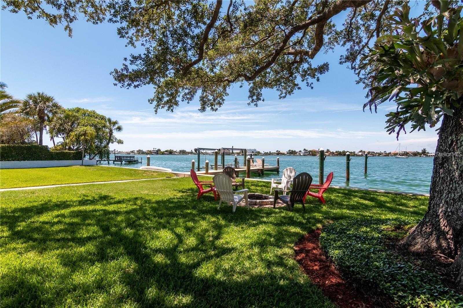 Prime oversized lot on Paradise Lane, Treasure Island, within walking distance to the beach, shopping, and dining. The street is adorned with large new homes. with additional ones under construction. The lot features a 6,902 sq ft rebuildable structure, or it can be cleared for you to construct your dream home. It is not located on a canal but offers open water bay and intracoastal views, with clam waters off the deep dock.