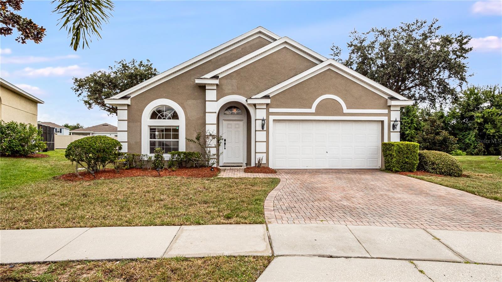 This beautifully appointed 4-bedroom, 3-bathroom home is situated on the largest lot in the community, offering unparalleled outdoor space and privacy. Located in a gated neighborhood just minutes from shopping, dining, golf, and Central Florida's top attractions, this property is ideal as a primary residence, second home, or income-producing short-term rental. Inside, the home features a spacious layout with two primary suites, perfect for extended family or guests. The main suite includes a luxurious en-suite bath with dual vanities, a Roman soaking tub, and a separate glass-enclosed shower. The open-concept kitchen is equipped with stainless steel appliances, upgraded cabinetry, and a center island ideal for cooking and entertaining. A separate interior laundry room is conveniently located just off the kitchen, and the home includes a full-size washer and dryer. The expansive living and dining areas have abundant natural light and comfortable flow for everyday living. Step outside to your private, screened-in lanai where a sparkling pool and relaxing hot tub await. With no rear neighbors and exceptional lot size, this backyard retreat offers both seclusion and ample room for outdoor living. The property also includes a two-car garage and generous driveway for additional parking. Residents enjoy access to community amenities including a playground, tennis and basketball courts, and gated entry for added peace of mind. With low HOA fees, no CDD, and proximity to Posner Park, top-rated schools, and major highways, this home offers the best of Florida living. Don’t miss the opportunity to own this one-of-a-kind property. All information is deemed reliable but not guaranteed. All measurements are estimates. The buyer must verify all information.