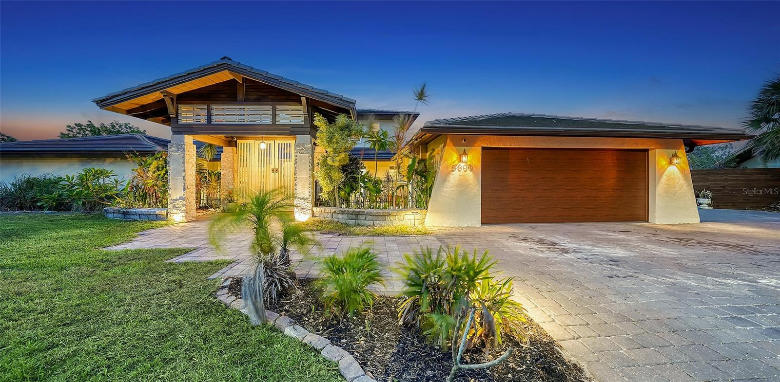 One or more photo(s) has been virtually staged. DOUBLE LOT ON A PRIVATE WATERFRONT PENINSULA! This property is the quintessential location for living an incredible Florida lifestyle. The home itself is unique, offering space that lends itself to anything you can imagine. With four bedrooms, some of which can be configured to other uses, and 4 full baths, this home is made for entertaining. But you may find the pièce de résistance is outside, as the oversized .61-acre lot is beautifully situated on two waterways just off Phillippi Creek. With over 400 feet of private water frontage, this property is truly your tropical oasis, quiet and peaceful, yet close to everything you need. The house itself has been continuously updated from 2017-2024. Exploring the interior, you will find a great room with a dual sided wood burning fireplace, large, updated kitchen with stainless steel appliances, farmhouse sink and pot filler. With 3 bedrooms on the first floor (one en-suite), and a master suite on the 2nd floor, there is room for residents and guests alike. The balcony off the 2nd floor provides gorgeous views, morning and night, with big blue-sky views to sunrises and sunsets. Want to feel like you are on vacation every day of the year? This home is made for tropical living. It has an outdoor tiki hut with a bar and grill, 2 outdoor fire pits, 5 zone outdoor exterior low voltage automatic night lighting, a pool, spa and boat lift. Other upgrades include a new boat house in 2019, new seawall in 2023/2024, two new A/C in 2019, and septic to sewer conversion in 2018. Tucked away at the end of cul-de-sac in Phillippi Gardens, the location is ideal, While the neighbor is private and quiet, it is close to The Landings and other shopping and eatery venues, a short bike ride to Gulf beaches, and not far from the vibrant downtown of Sarasota and all its cultural and recreational offerings. You truly must see this amazing property to appreciate all it has to offer.