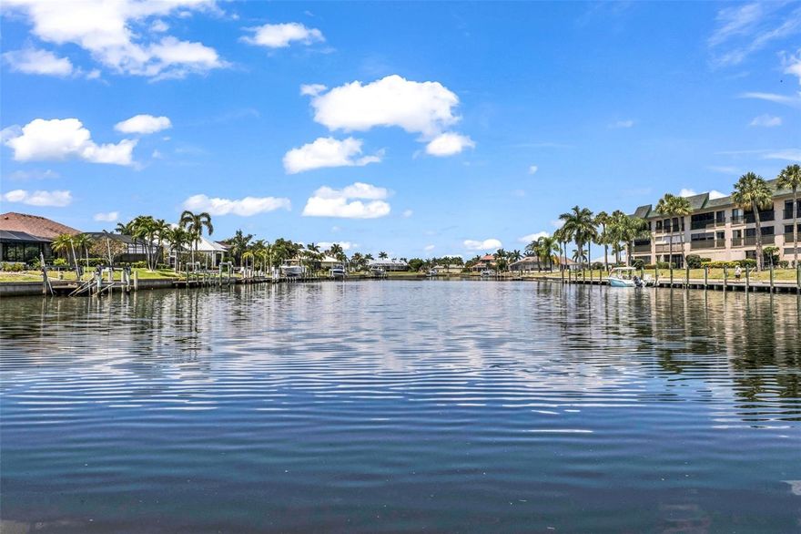 LONG WATER VIEW with AMAZING SUNSETS!!!  This former BUILDER'S MODEL has it all, and it comes Turnkey Furnished and ready for occupancy.  A thoughtful design for todays living includes an open floor plan, high ceilings, HEATED pool and spa, boat lift, upgraded flooring, solid wood cabinetry, high quality granite counters, stainless steel appliances, oversized garage, manabloc plumbing and stunning views from several rooms.   Exterior features include a circular driveway, HUGE brick lanai with a PANORAMIC SCREEN ENCLOSURE, accordion hurricane shutters, gorgeous aquarium window in the dinette, a NEW TILE ROOF in 2023 and several new windows in 2022. QUICK TIME OUT TO THE HARBOR, and you are enjoying the sweet life of our quaint fishing and boating community.  The home is situated withing walking or biking distance to the History Park, Isles Civic Center, Fishermen's Village, Dog Park and Downtown Punta Gorda.  This home checks off every box on your wish list.  ***FEMA flood policy is transferrable***  Make an appointment today to see this GORGEOUS HOME before its too late!!!